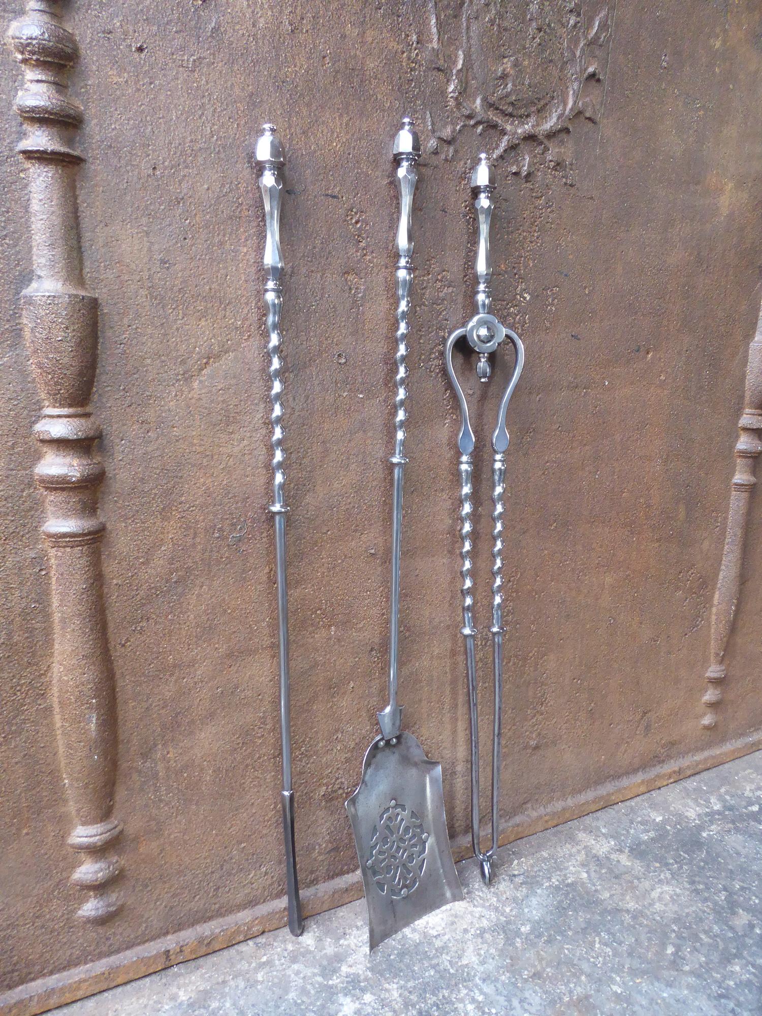 18th-19th century English Georgian fireplace tool set. The fine fire irons are made of polished steel. They are a good condition and fully functional.