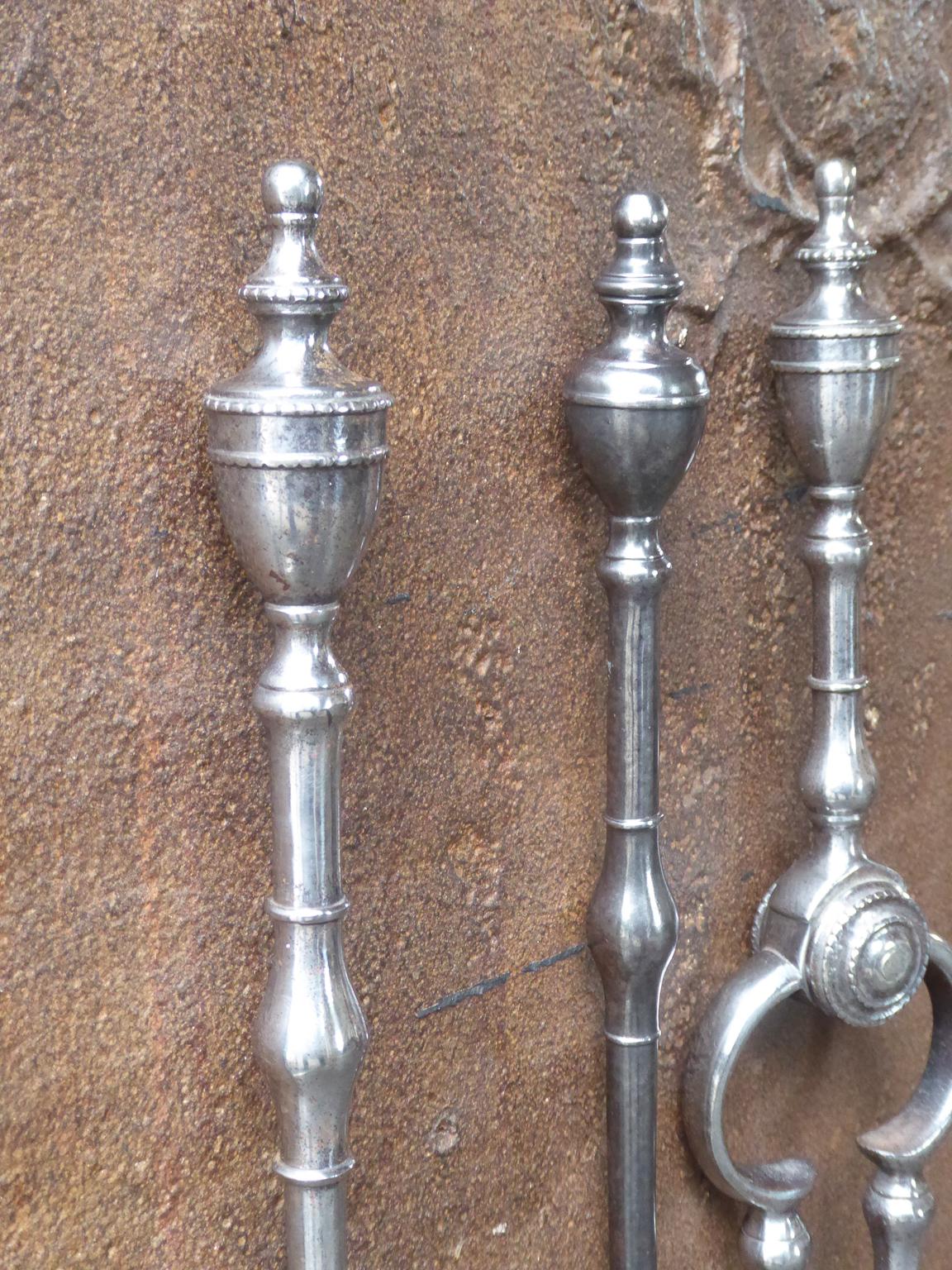Elegant Georgian set of of three tools with bulbous sections on the shafts, with tall lidded and knopped urn finial handles and a finely pierced & cut shovel. The fire tools are made of polished steel. The set is in a good condition and is fully