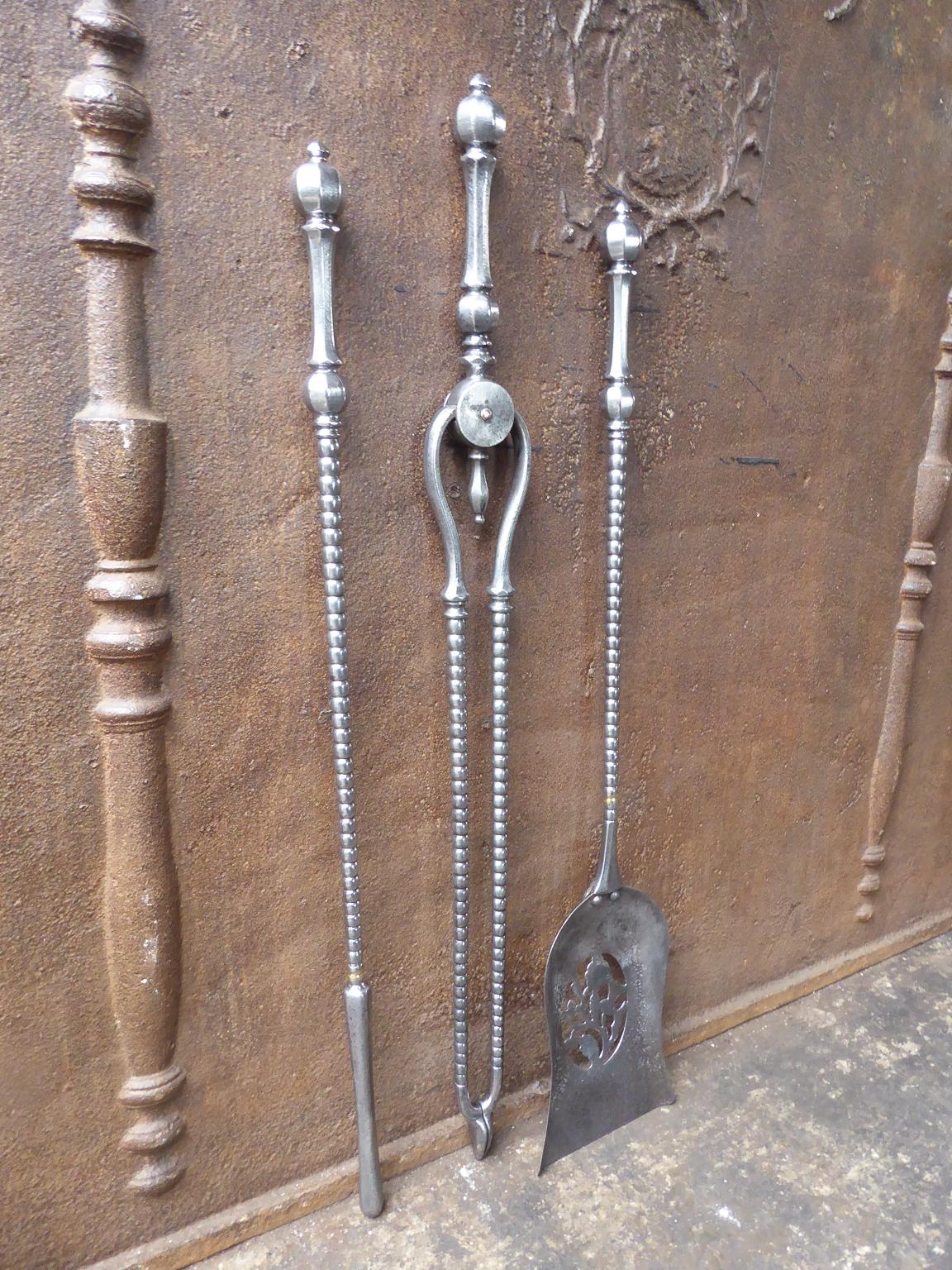 Elegant Georgian set of of three tools with barley twist shafts, ball-knopped finial handles and a finely pierced & cut shovel. The  fire tools are made of polished steel. The set is in a good condition and is fully functional. 