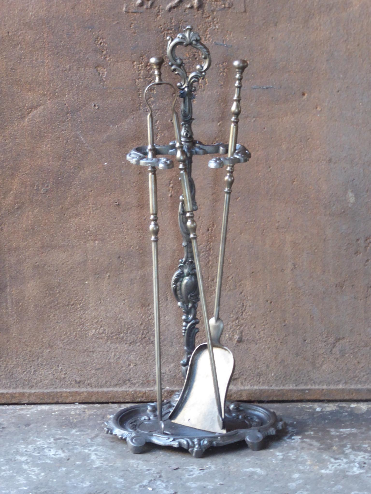 18th - 19th century English Georgian period fireplace toolset made of wrought iron and cast iron. The toolset consists of three fire irons and a stand. The condition is good.













 