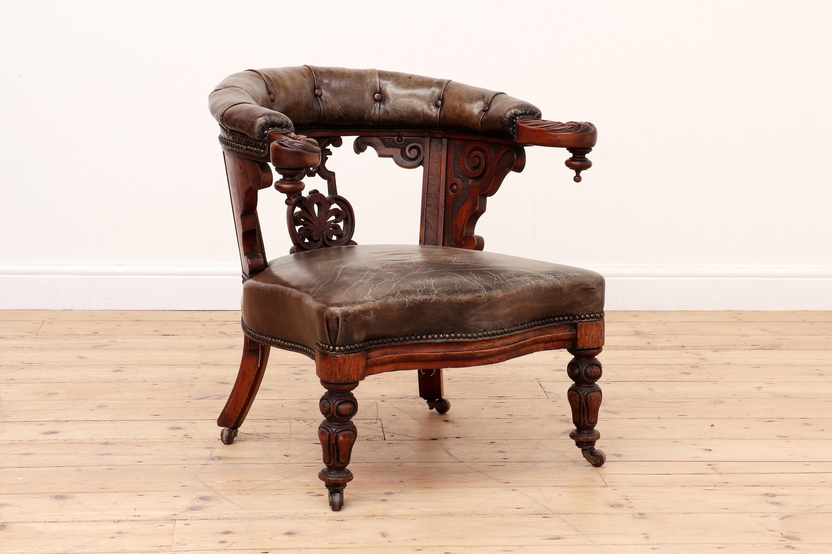 Antique English 19th century Georgian Gillows Of Lancaster leather library chair c.1830

An oak and leather armchair. The curved back terminating in scroll arms above a shaped splat and stuffed seat, on ring-turned front supports and castors.

A