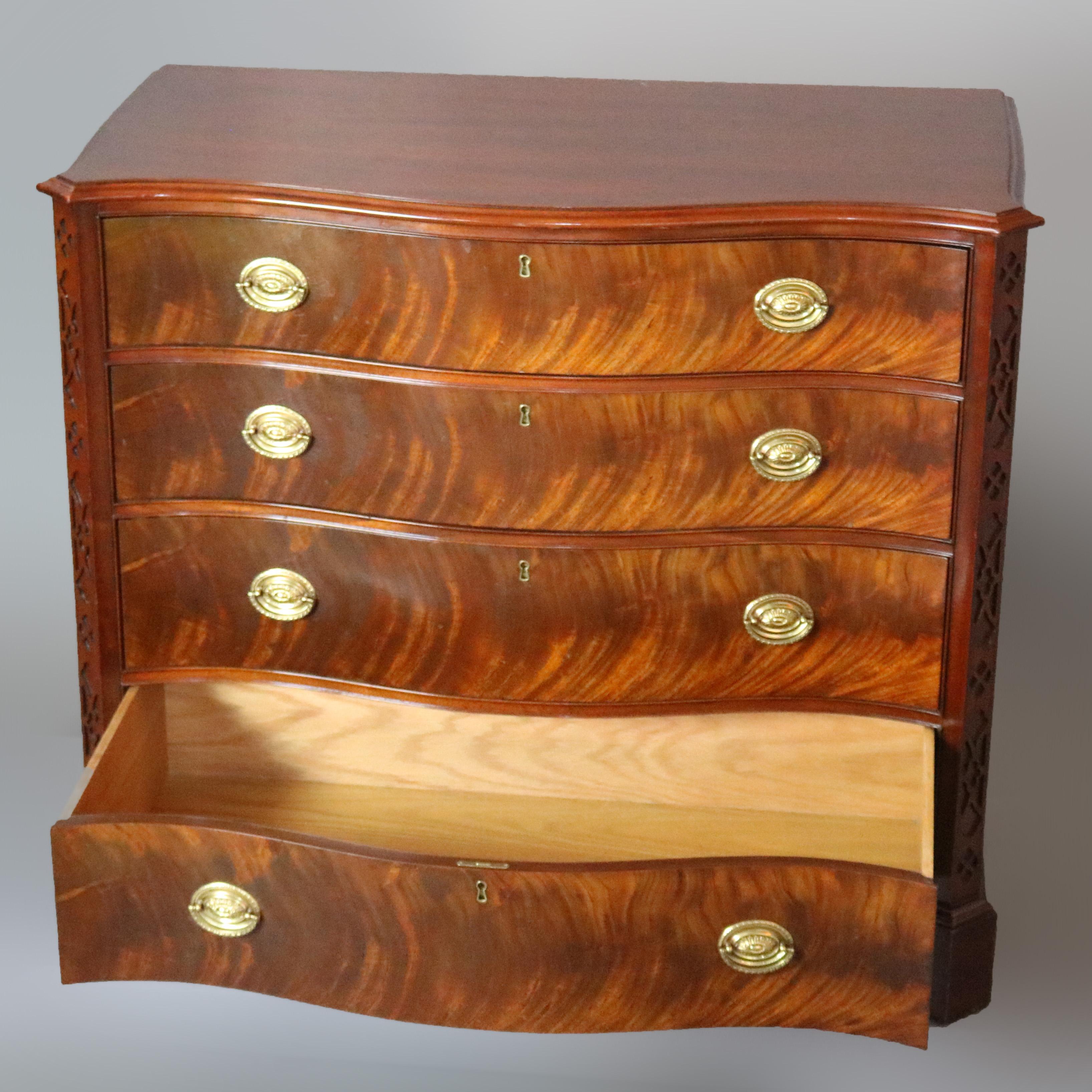 An antique English Georgian III style limited edition chest of drawers by Hickory Chair of the James River collection offers deeply striated flame mahogany construction with swell front form, raised on bracket feet and having cast brass pulls, maker