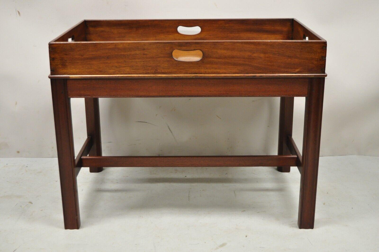 Antique English Georgian mahogany Butler's Style coffee table with Dovetail. Item features dovetailed joints, stretcher base, (4) carved handles, solid wood construction, beautiful wood grain, very nice antique item, stamped 