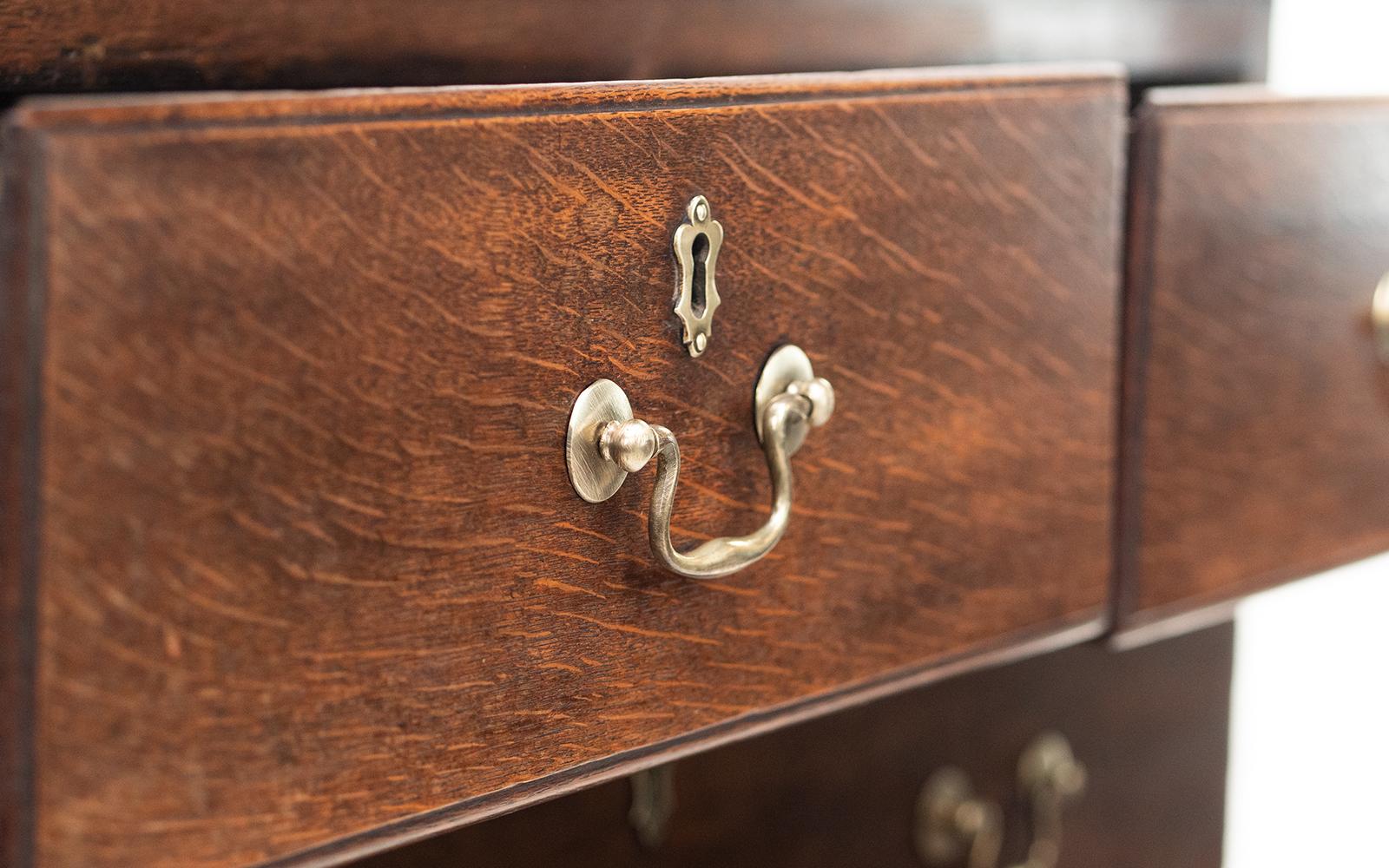 Georgian chest of drawers

A late Georgian chest of drawers with terrific character and patina.

George III mahogany chest of drawers. Two short drawers over three long, original brass swan neck handles, raised on shaped bracket feet.