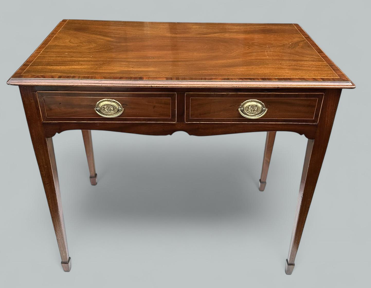 A Very Imposing example of an English Georgian flame mahogany rectangular Lady’s twin drawer Desk or occasional side table of compact proportions. Circa 1800-1820. 

The rectangular surface above a shaped apron, enclosing oak lined twin drawers,