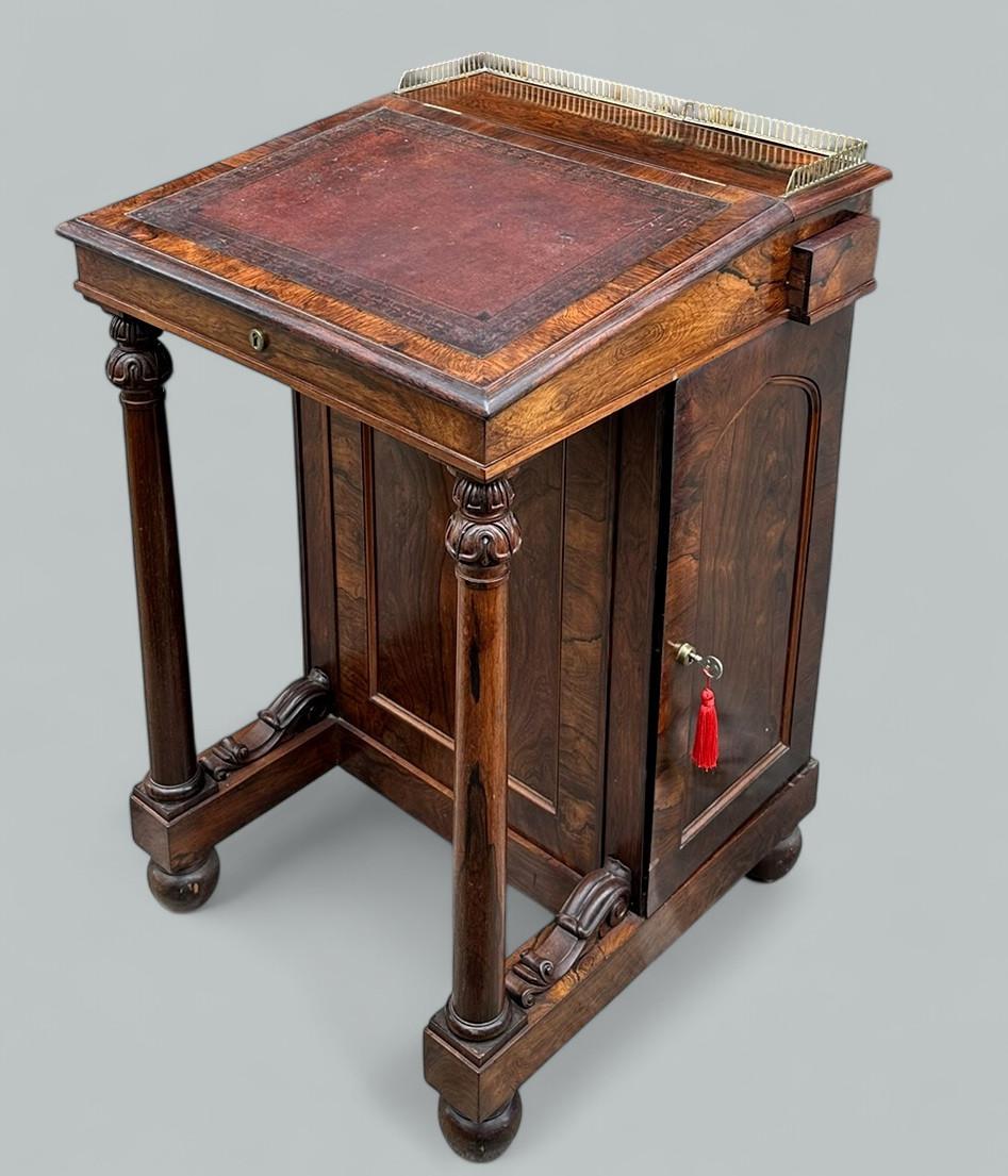 A Very Imposing example of an English well figured Rosewood late Regency Period Davenport Desk or occasional side piece of compact proportions, in the manner of renowned Cabinet Makers Gillows of Lancaster and London. Circa 1815-25. 

The polished