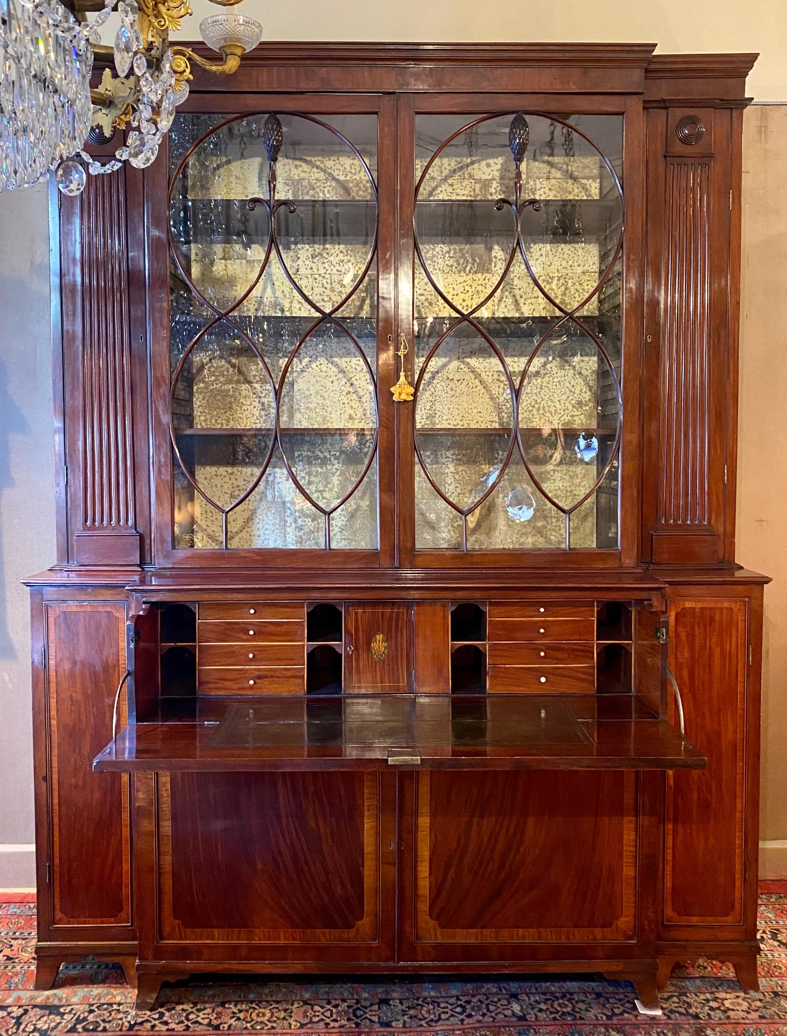 Antique Early 19th Century English Georgian Mahogany with Inlay Secretary Breakfront, Circa 1840.
Secretary has a fitted interior, and shelving space above has a lighted interior.
