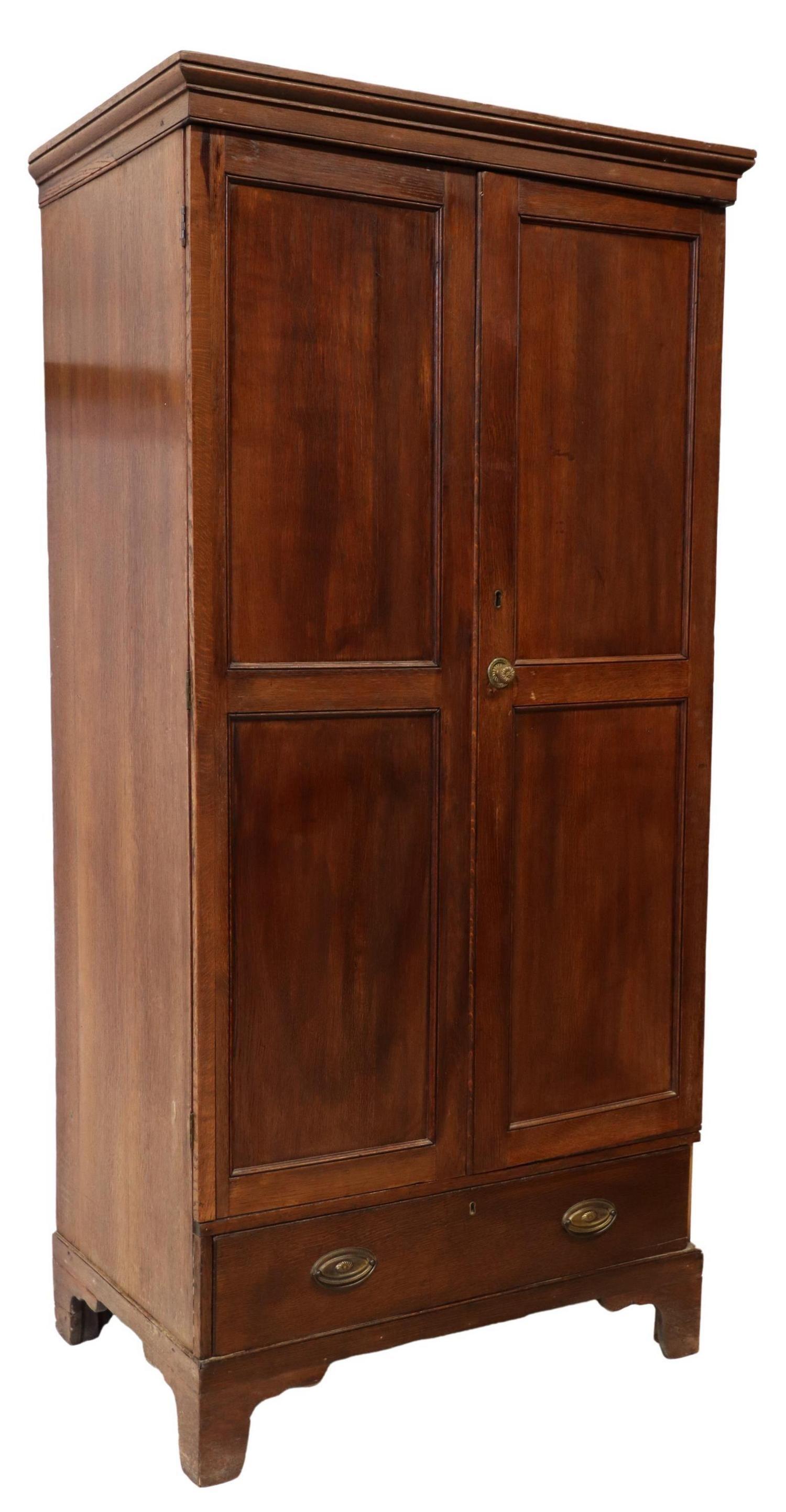 Antique English Georgian oak cupboard, 18th/ 19th c., molded cornice, two paneled doors, lower exterior drawer, on bracket feet, loss to trim at right side of drawer.

Dimensions:
Approx 76.5