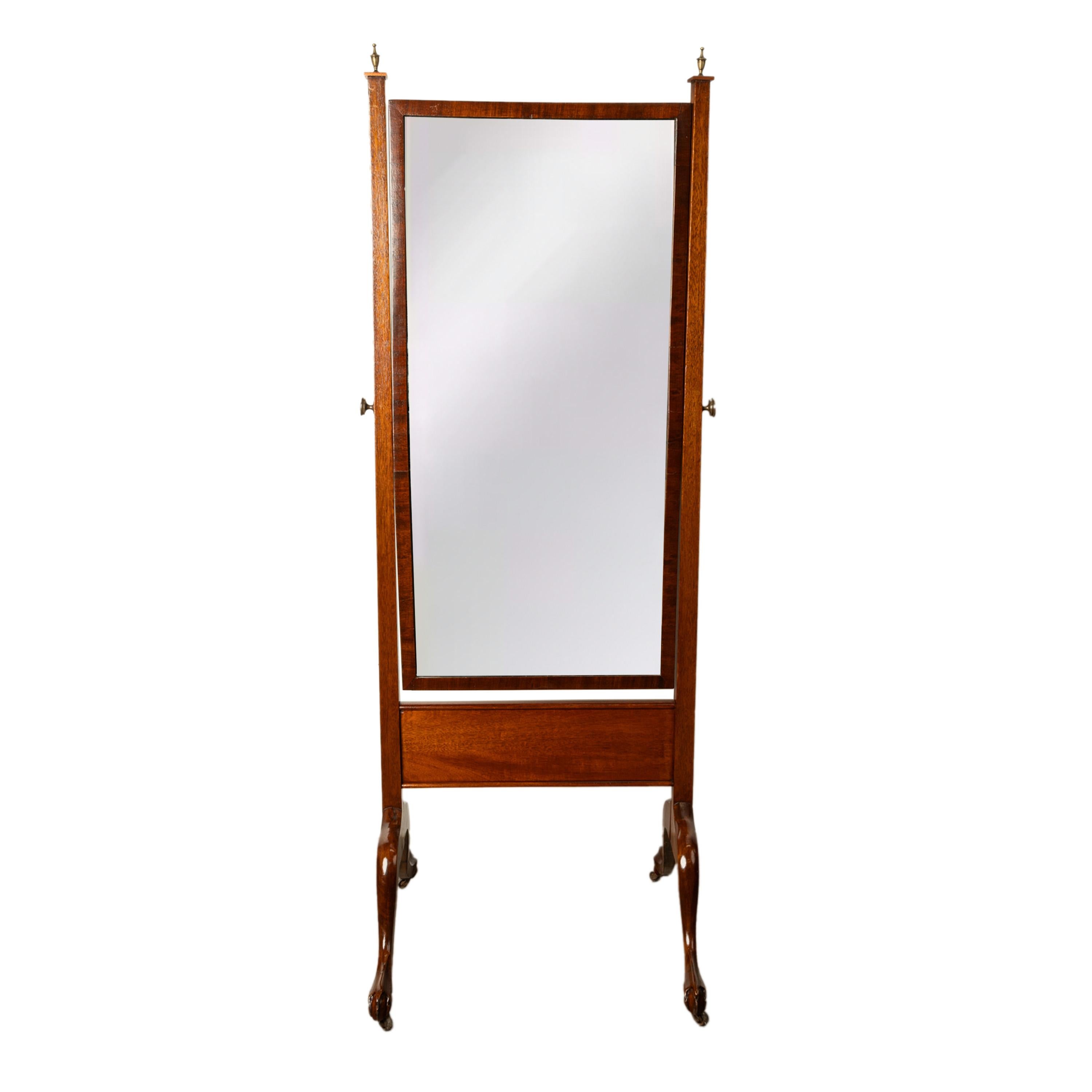 A good antique Georgian Regency mahogany cheval mirror, circa 1820.
The mirror having a pair of brass urn shaped finials to the top of the upright supports, to the center is a swing mirror, the mirror plate seems to be original. The mirror can be