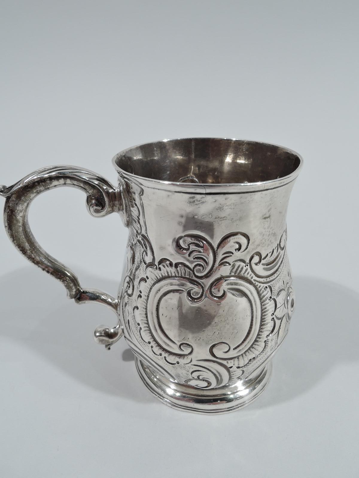 English Georgian sterling silver baby cup, 1760. Baluster bowl with leaf-capped double-scroll handle and raised foot. Chased and repousse flowers, leaves, and scrolls. Fully marked including London assay stamp and maker’s stamp TC. Weight: 4 troy