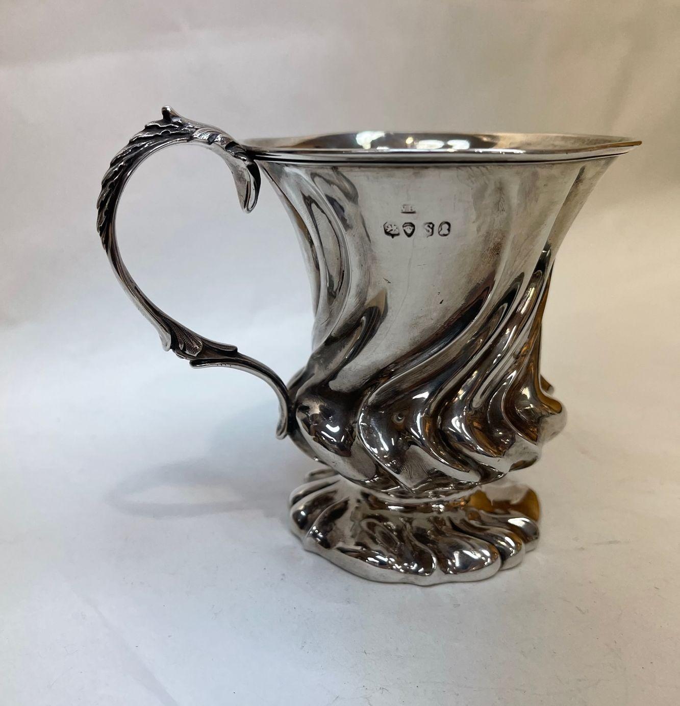 Fine and Impressive Antique William IV English Sterling Silver Baby Cup. Baluster with scalloped body and leaf-capped double scroll handle; on round foot. Fully marked. Hallmark. Corresponds to London 1834. Weight: 4.308 troy ounces. 
  