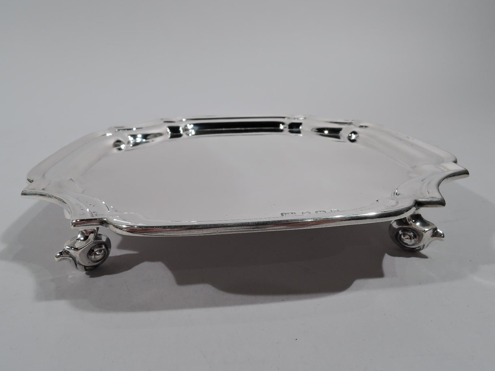 George VI sterling silver salver. Made by Edward Viner in Sheffield in 1938. Four curved sides with curvilinear concave corners. Molded rim and capped volute scroll supports. Fully marked. Weight: 9.5 troy ounces.