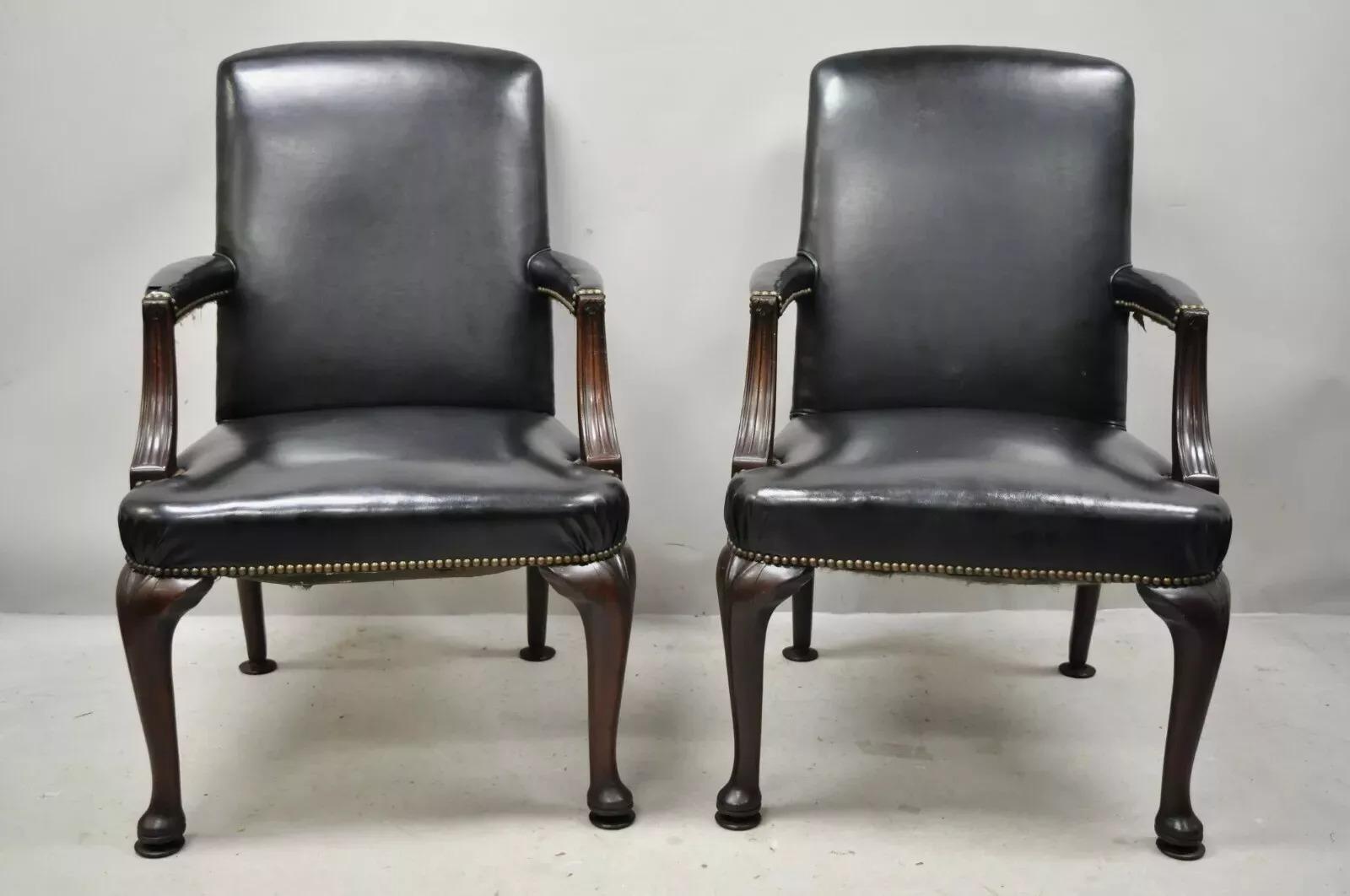 Antique English Georgian Style Dark Green Leather Library Office Chairs - a Pair. Item features nail head trim, solid wood frame, upholstered armrests, dark green leather upholstery, very nice antique item, quality American craftsmanship. Currently