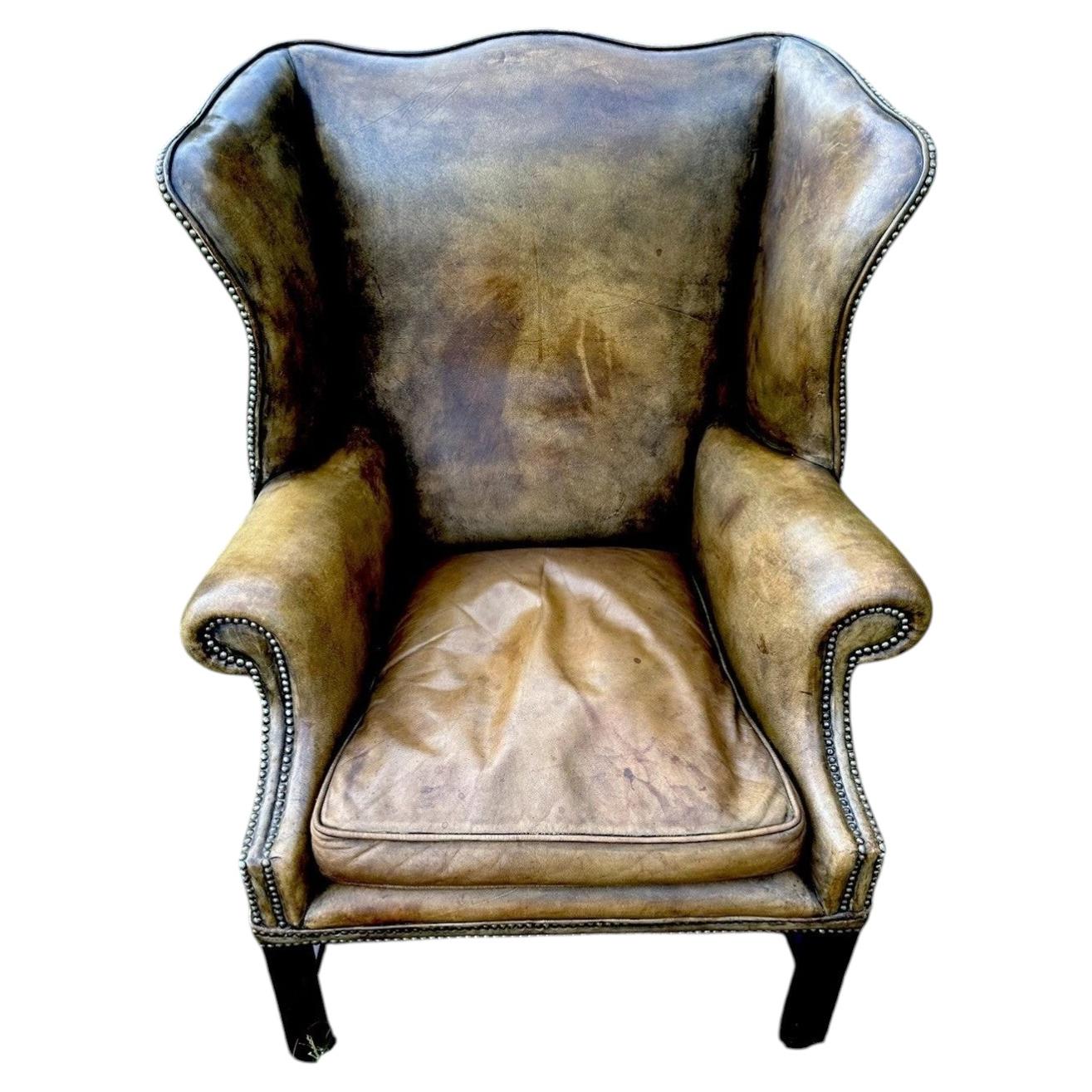 Antique English Georgian Style Distressed Tan Leather Wingback Library Armchair For Sale