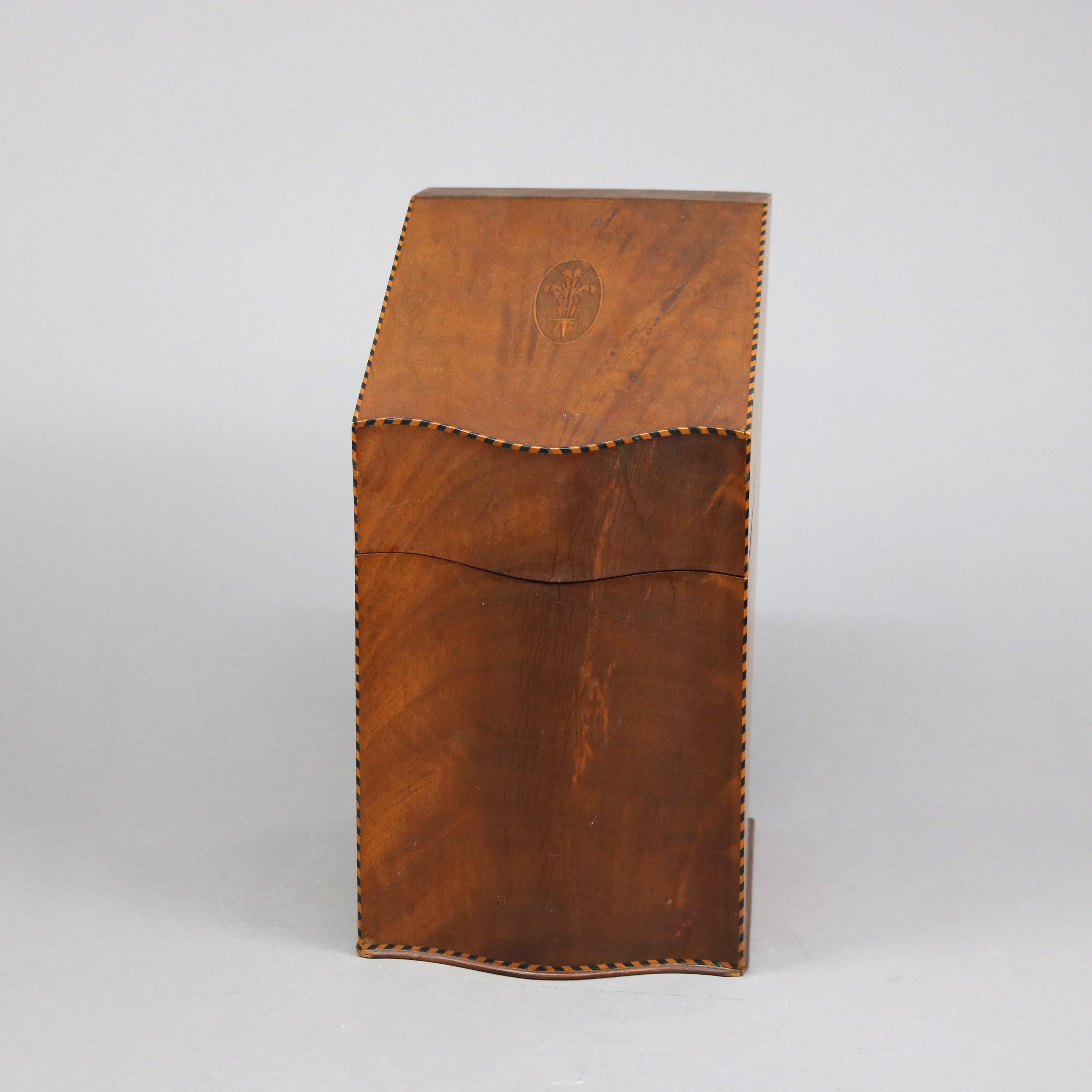 An antique English Georgian style knife box offers flame mahogany construction with swell front and slat top having satinwood marquetry reserve of tied wheat, banded in ebonized dental trim, 19th century

Measures - 14.5