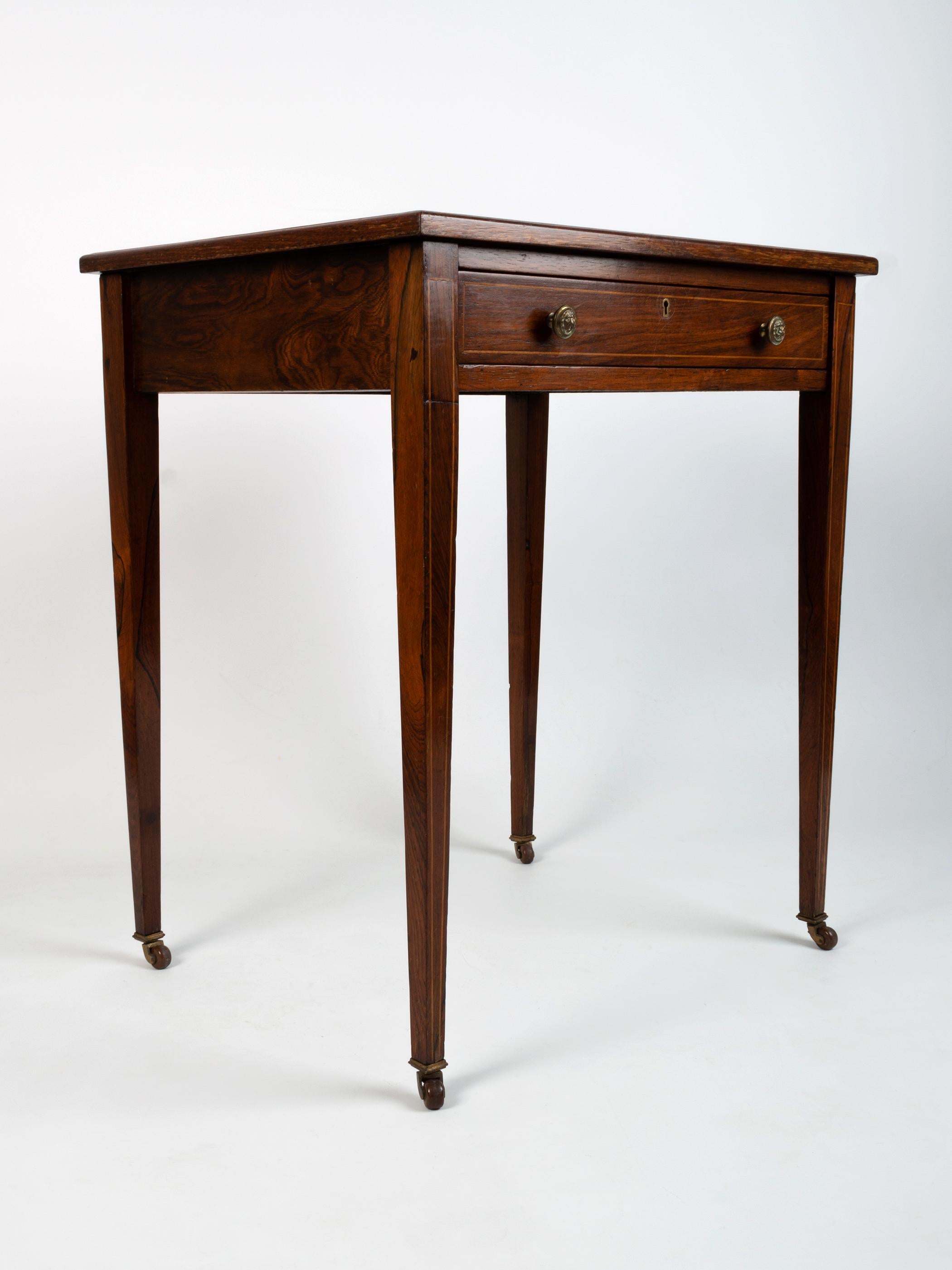 Antique English Georgian Style Rosewood Leather Inlaid Writing Table C.1900.

A neatly proportioned desk, beautifully inlaid. Clean lines and simple design in the classic George III manner.

The cross banded top surface is presented with a