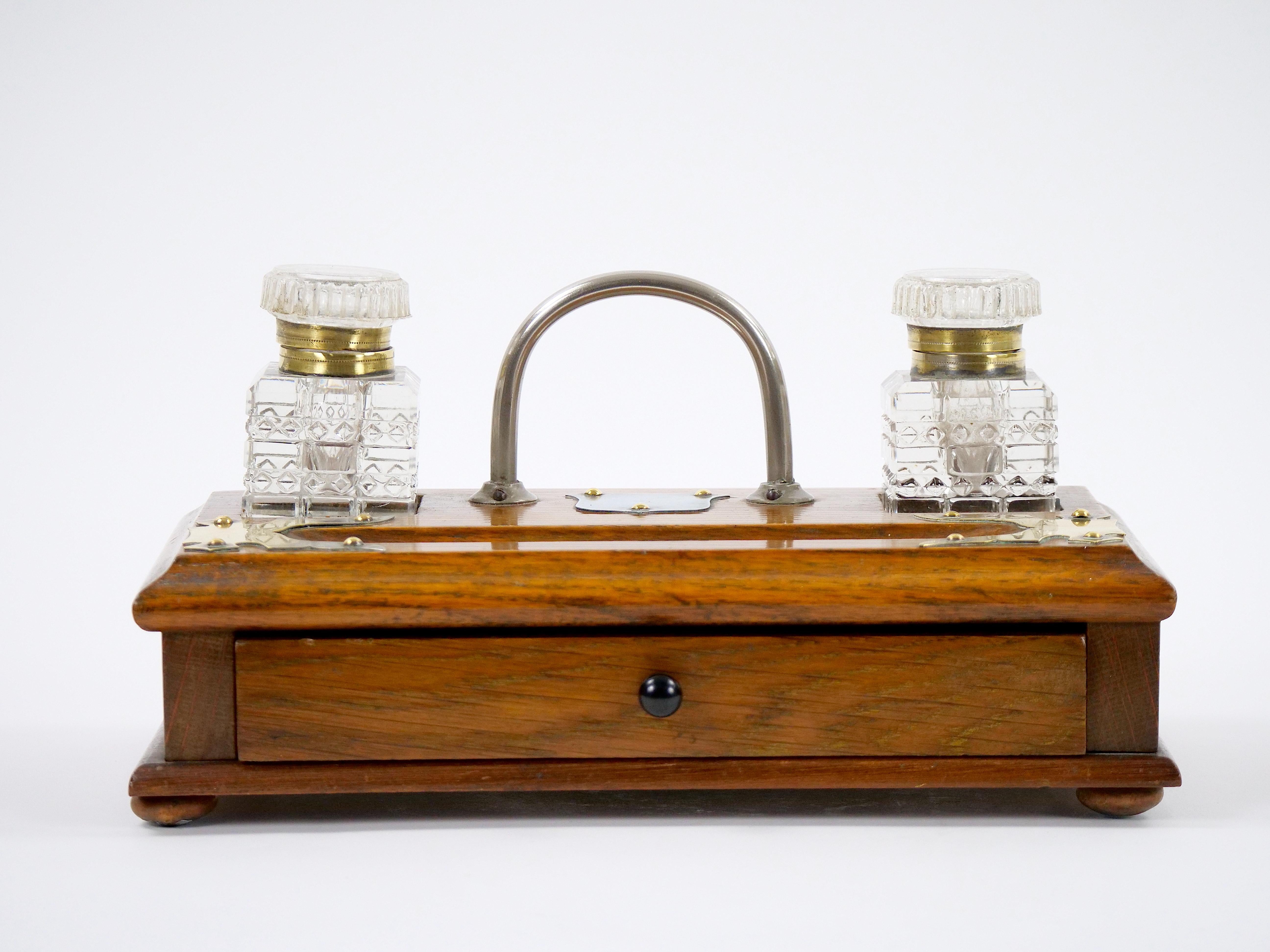 Introduce a touch of vintage elegance to your workspace with this Antique English Georgian Walnut, Mahogany, and Cut Glass Inkwell, a refined desk accessory that exudes timeless charm and sophistication. Crafted during the Georgian era, this inkwell