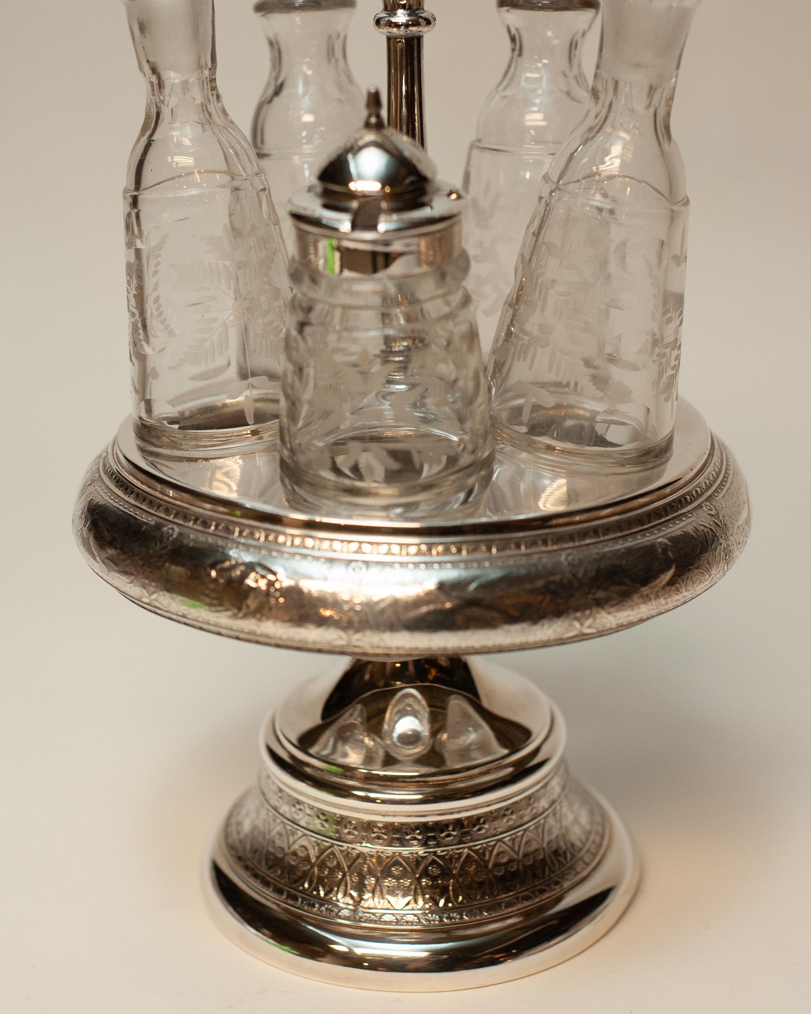 A beautiful antique English sterling silver-plate condiment set with glass and silver plate dispensers. Made in England circa 1920.