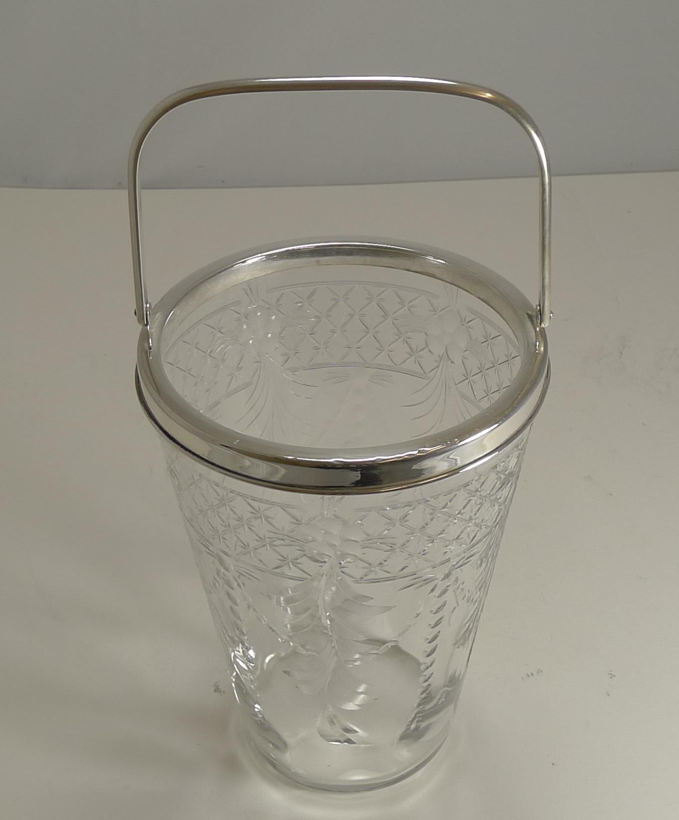 A wonderful slim and tall ice bucket ready to fill with cubes and adorn the finest of bars.

Edwardian in era, dating to circa 1910, the glass is quite exquisite with fine hand-engraved work.

The fittings are silver plate. Excellent all round