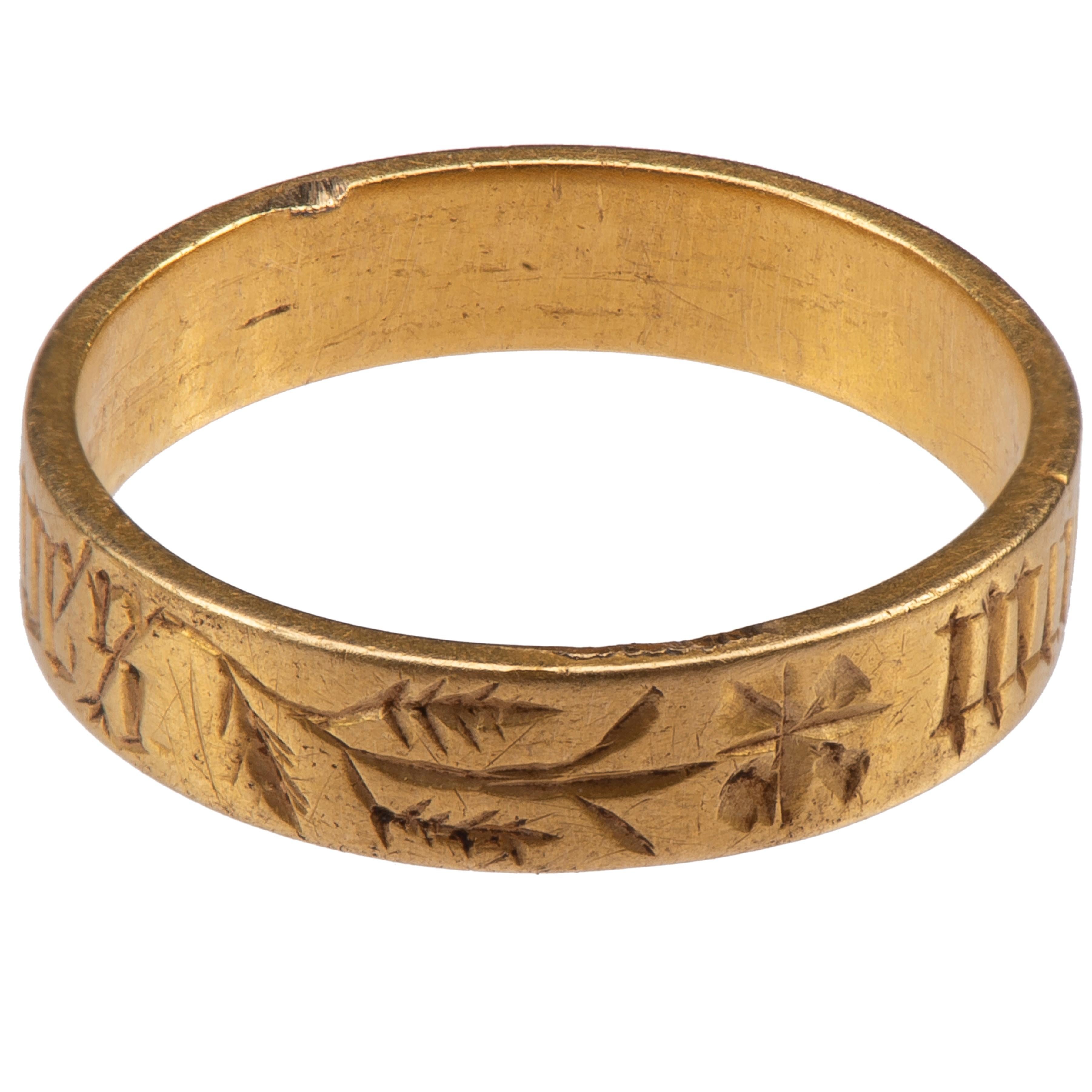 Posy ring with ‘MON COER AVES’
England, c. 1450
Gold
Weight 3.2 gr; Circumference 53.82 mm; US size 6 3/4; UK size N ½
	
Description:
Wide gold band, plain on the interior and engraved on the exterior with the black letter inscription in French: 
