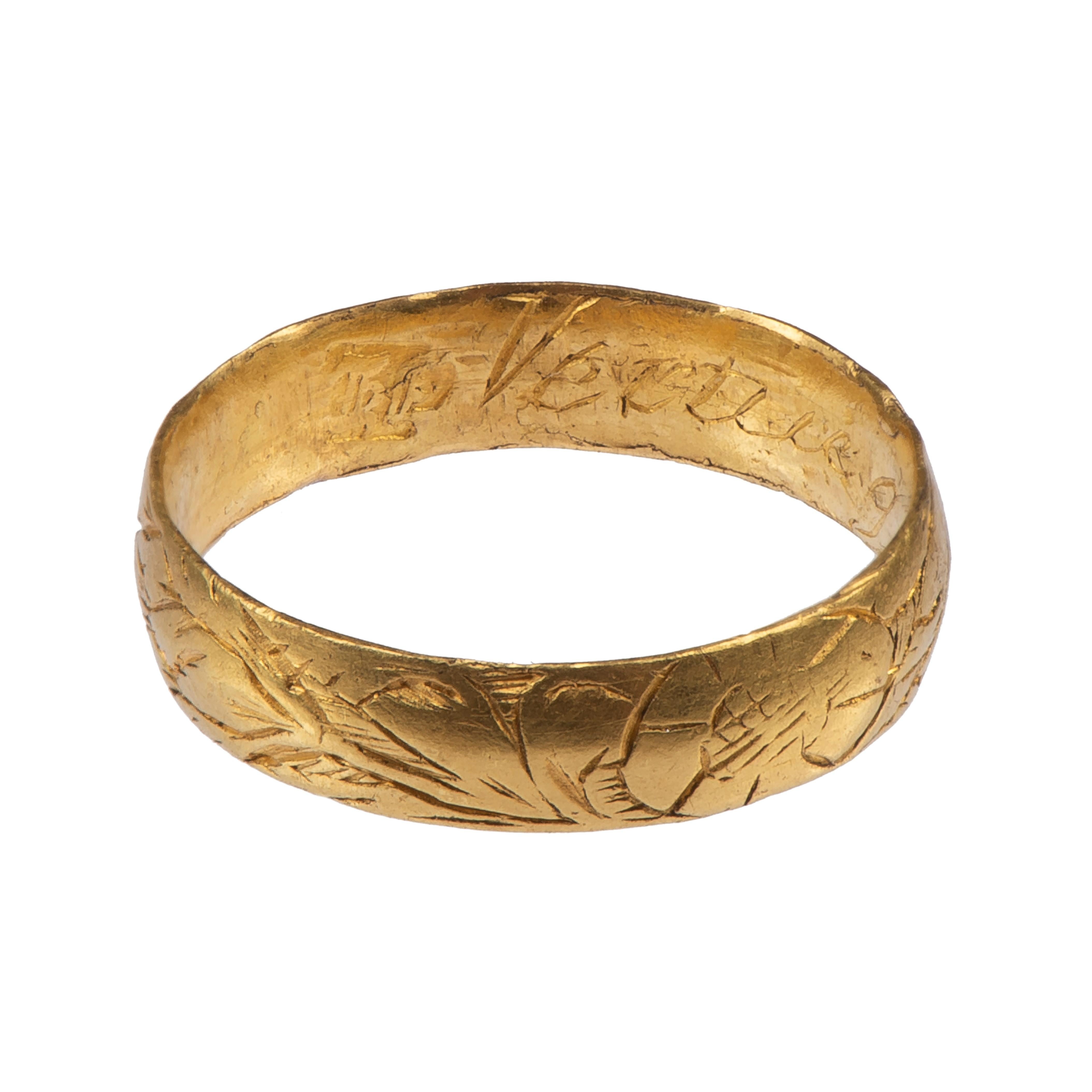 Posy Ring ‘Vertue Gaineth Glory’
England, c. 1700
Gold
Weight 2 gr.; circumference 46.68 mm.; US size 4; UK size H ½

Posy ring featuring floral decoration including daisies and tulips. 
Wide gold band, plain on the interior with engraved English