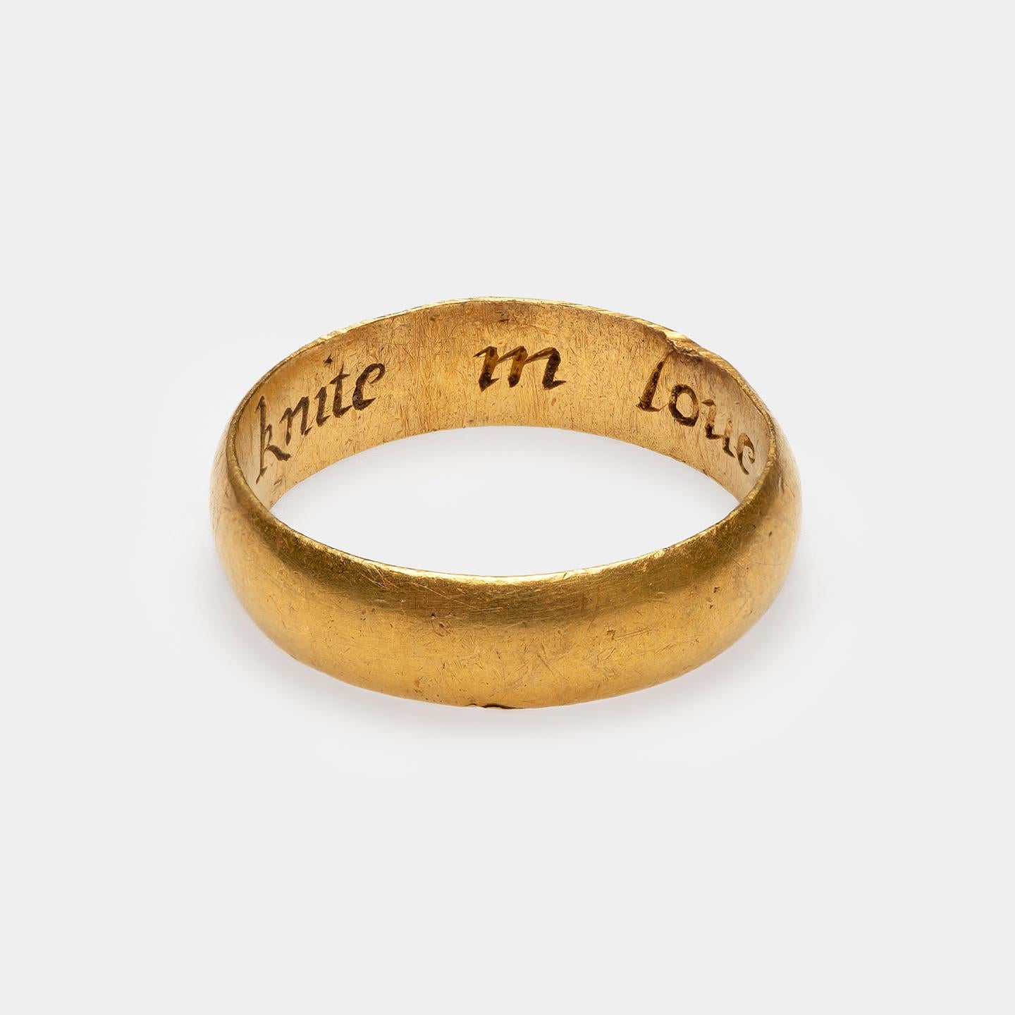 Posy Ring “A knote knit in love”
England, late 17th century
Gold
Weight 5 gr; Circumference 57.65 mm; US size 8 1/4; UK size Q 1/2

A wide gold band with D-section and inside the engraved italic inscription “A knote knit in love.” The ring shows