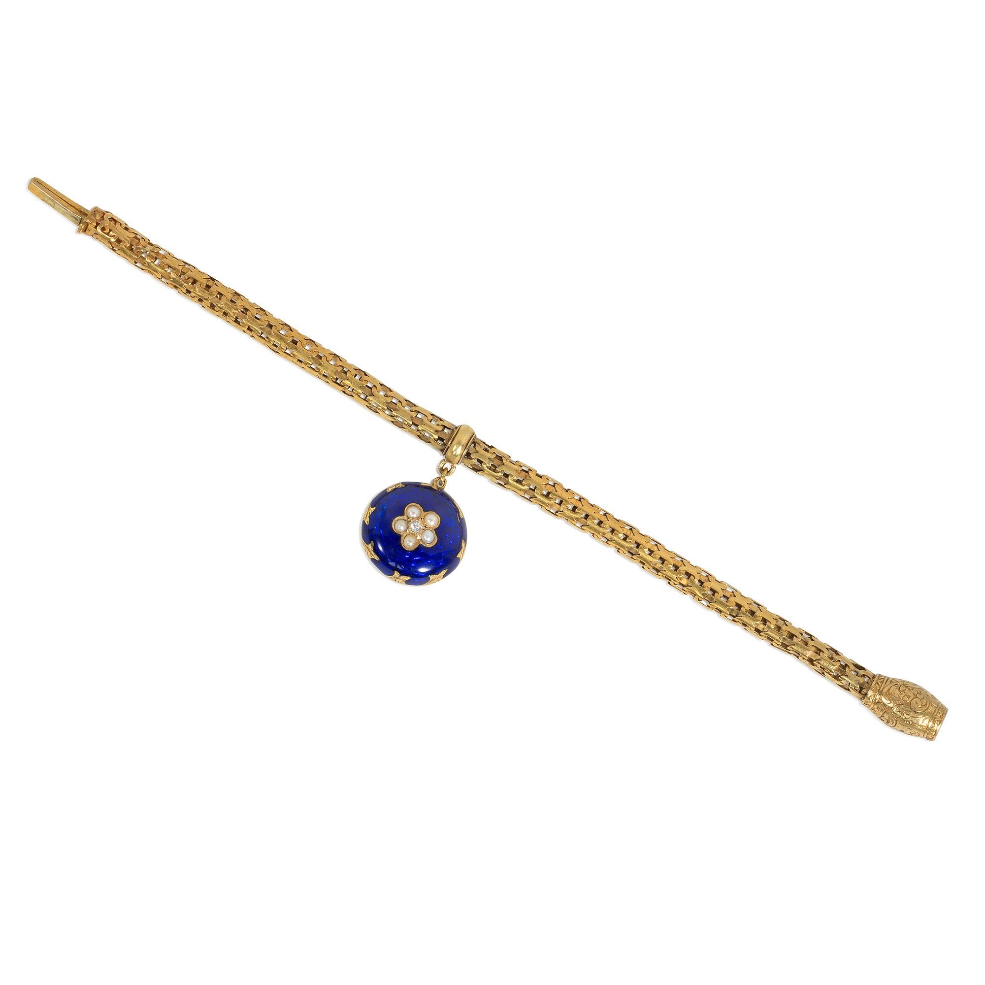 An antique mid-Victorian gold fancy-link tubular bracelet suspending a blue enamel locket-backed charm pendant set with a pearl and diamond flower cluster, completed by an engraved foliate barrel-shaped closure with a turquoise accent, in 18k. 