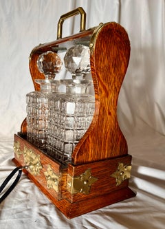 Antique English Golden Oak Two Bottle Tantalus, Circa 1890.