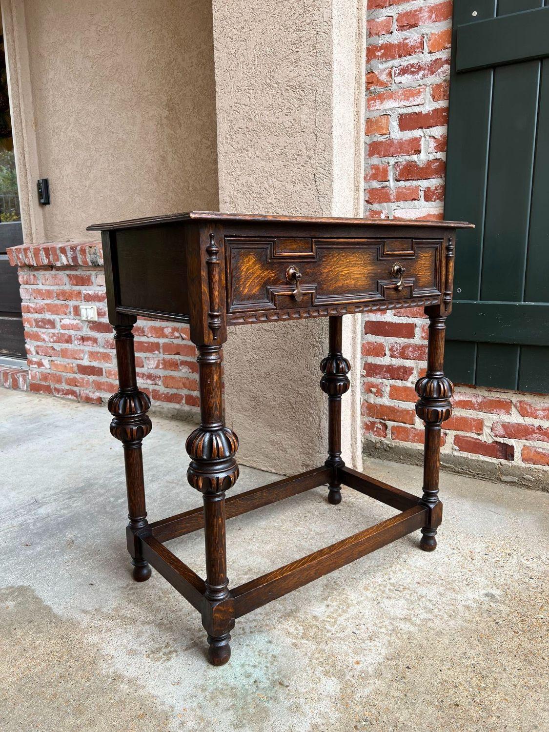 Antique English hall sofa table Jacobean carved oak c1920.

Direct from England, a charming British sofa or hall table. Classic Jacobean style with a geometric paneled wide front drawer and original brass drop drawer pulls. Jacobean trim to either
