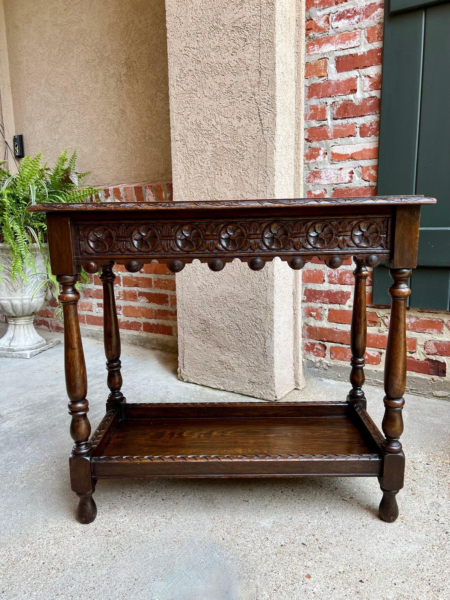 Antique English Hall Sofa Table Petite Carved Oak Library Arts & Crafts.

Direct from England, a lovely antique hall table with beautiful silhouette and classic British style!
Fully carved table top with center flower medallion and scrolls that