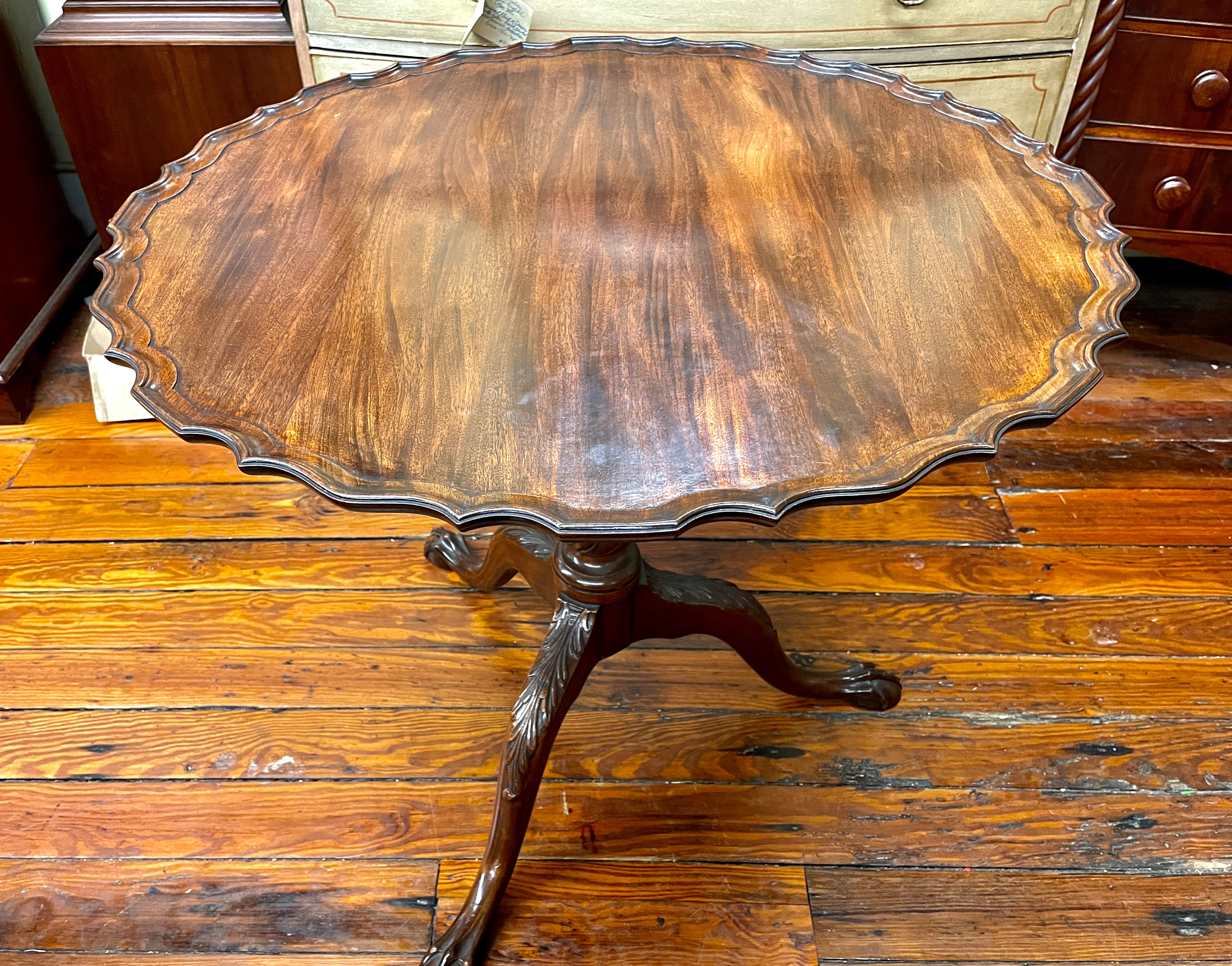 Fabulous old English hand-carved mahogany Chippendale style tip top piecrust tea table. 

Please note the finely hand-carved pedestal, splayed legs, and rotating 