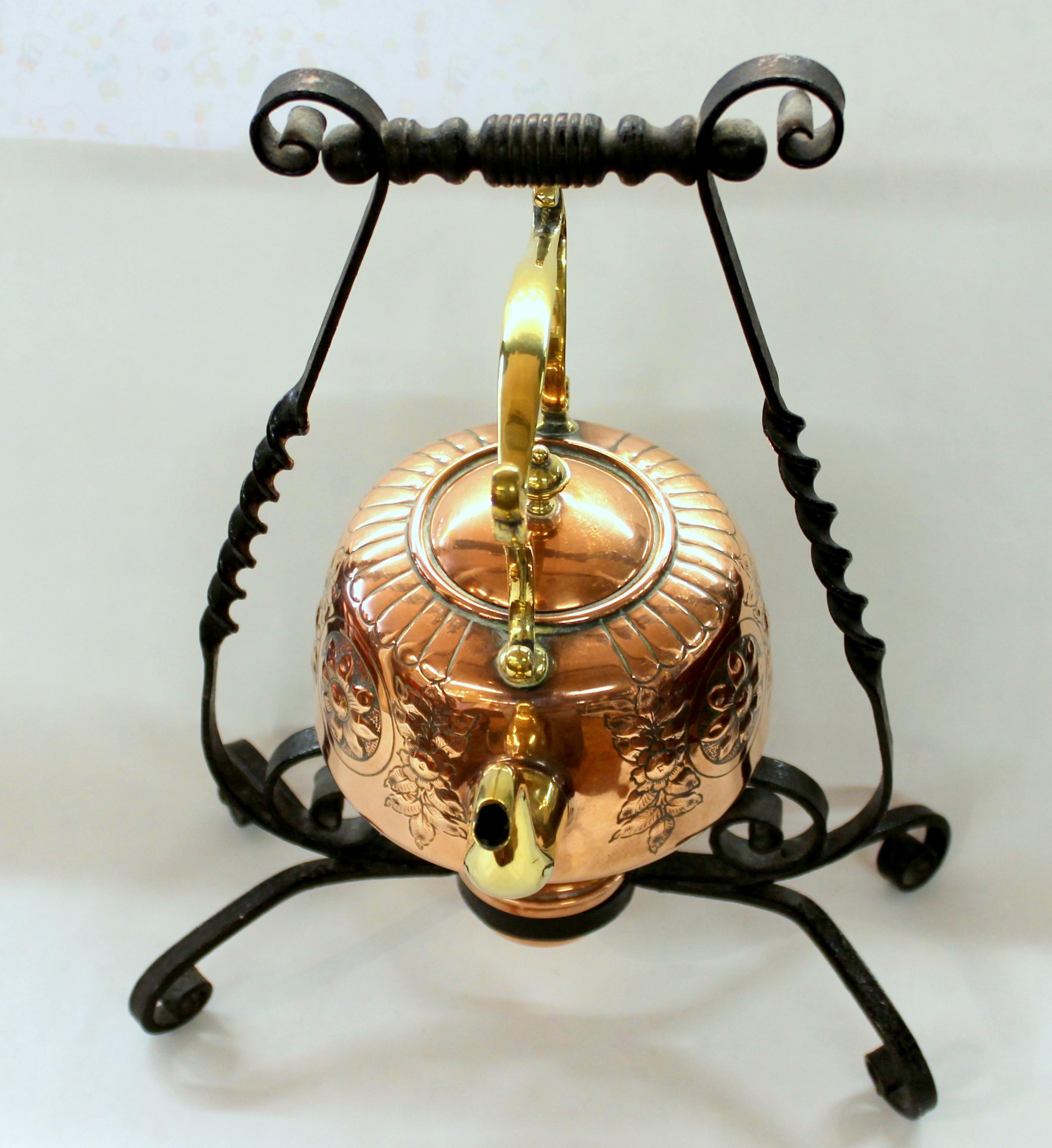 Fine and rare antique English hand chased copper and brass kettle on original wrought iron stand with original copper burner.

Please note lovely handwrought iron stand and beautifully hand chased original copper kettle and burner.