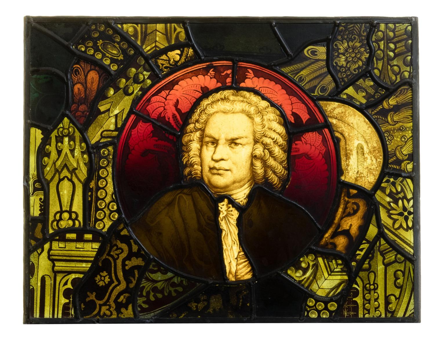 An antique stained glass window panel depicting the composer J.S Bach, in period dress.
