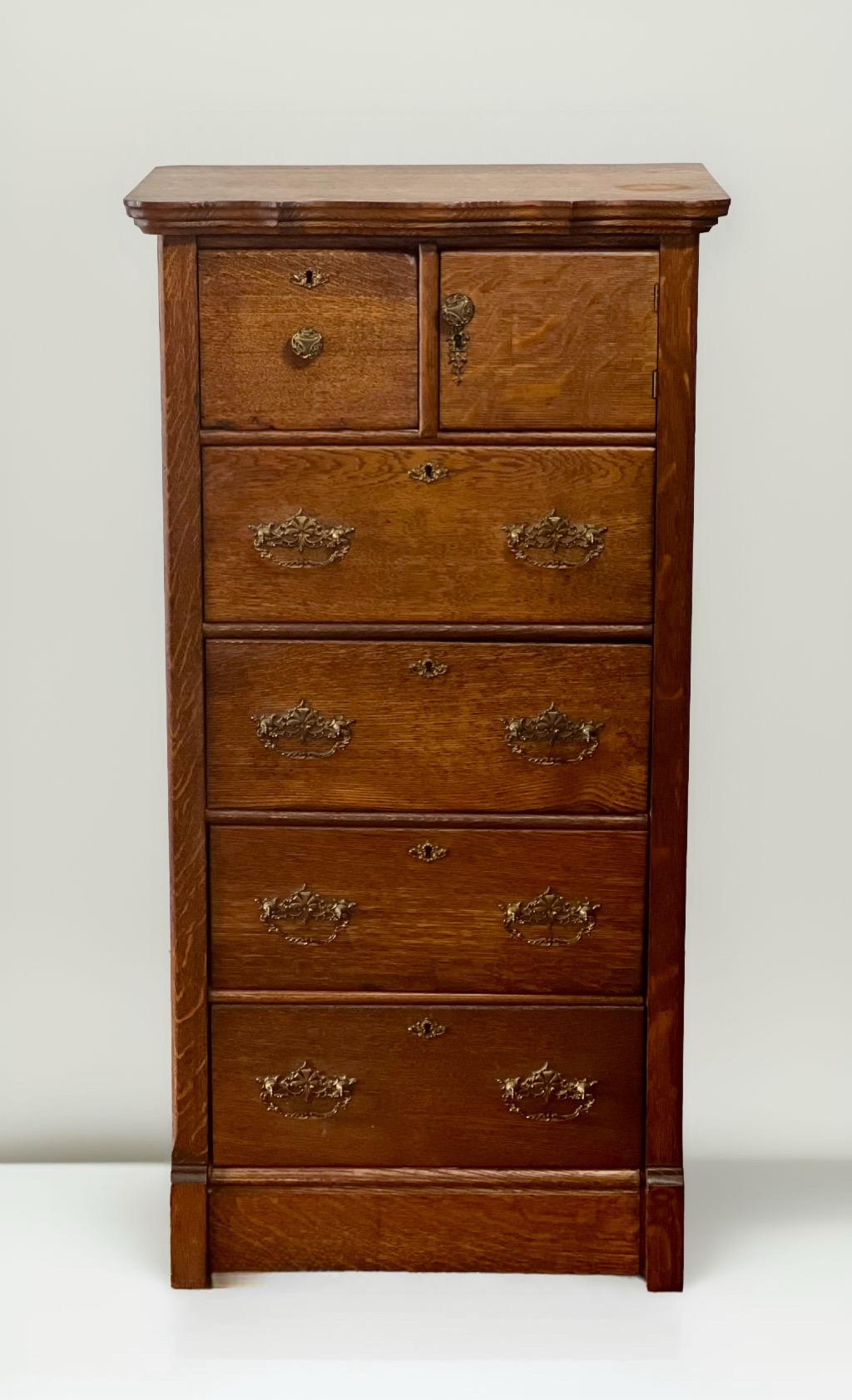 English quarter sawn oak lingerie chest, c. 1900.

Rare all handcrafted bonnet lingerie chest of warm toned oak with original brass hardware. It has hand dovetailed drawers and solid construction with an immaculate interior. Chest features a doored