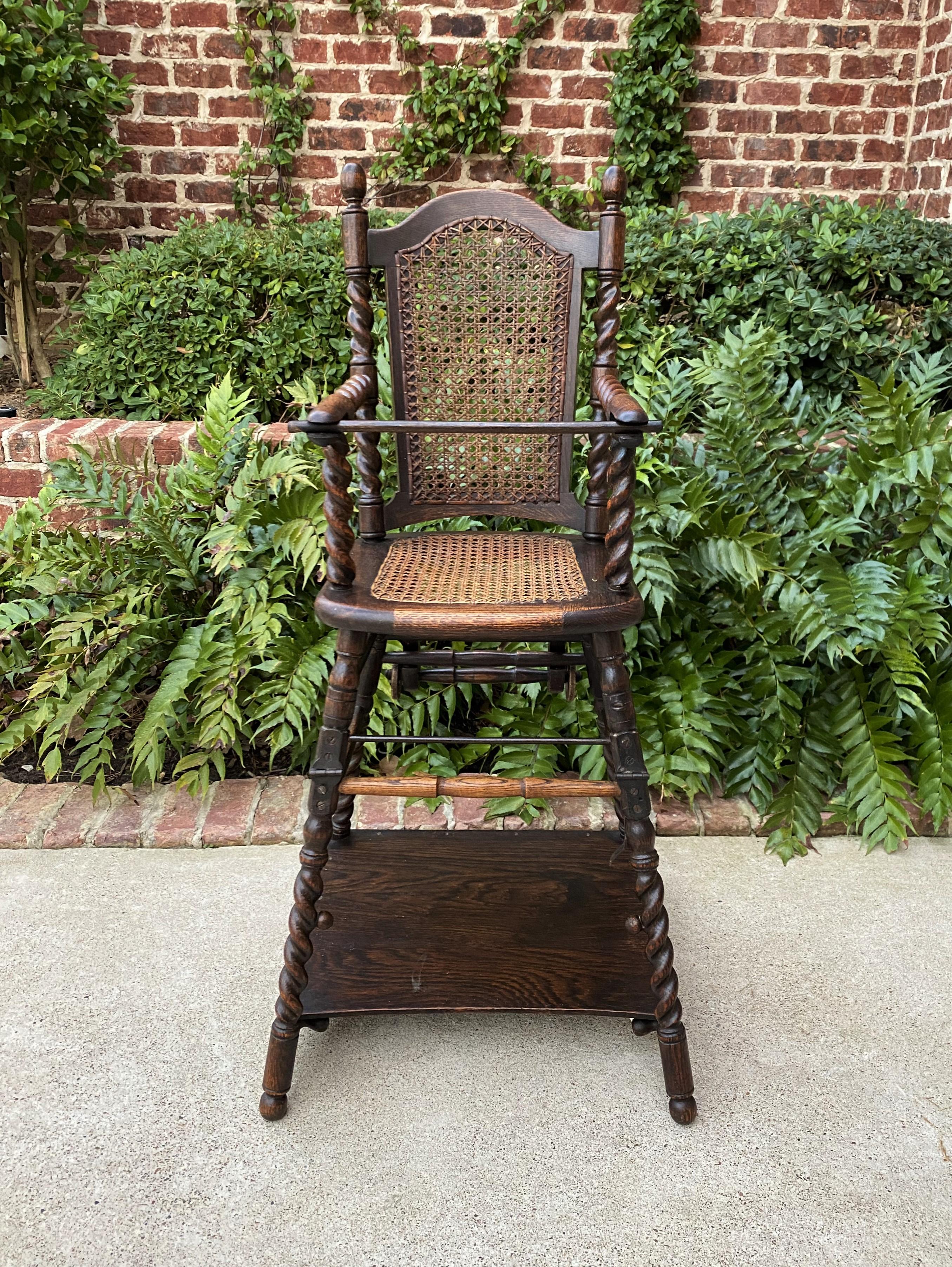 Rare antique english child's high chair~~caned seat with barley twist arms and splayed legs~~converts to smaller child's chair or walker~~maker's tag~~Victorian era~~c. 1910s-20s

This is must see~~so rare~~convertible antique child's high chair