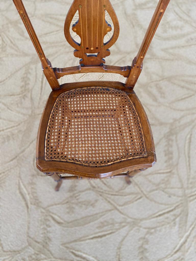 This antique English high chair can be used as a display for dolls, etc. Hand made and carved with a cane seat turned legs, Circa 1880.