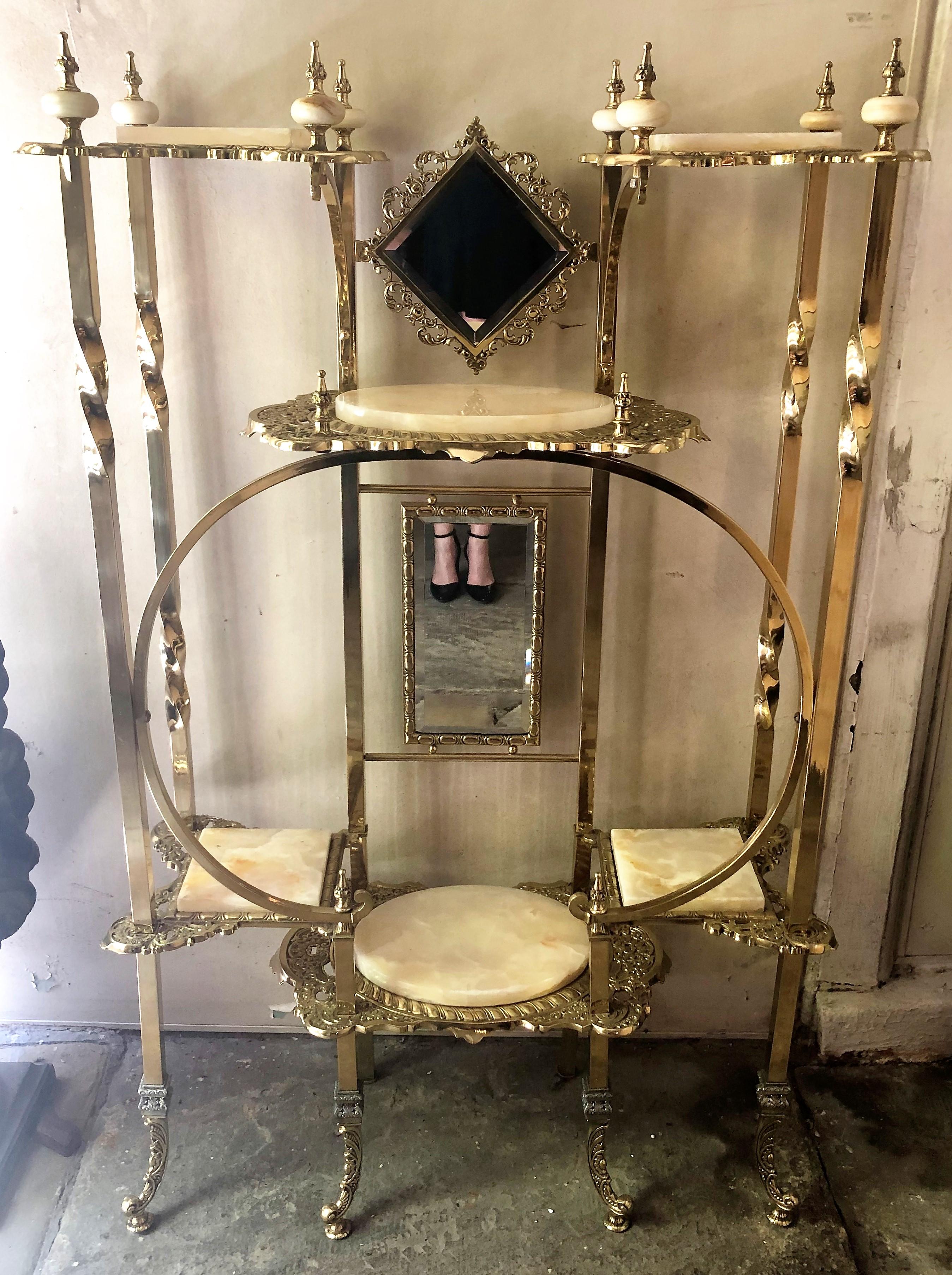 Antique English high Victorian brass and onyx étagère with beveled mirrors, circa 1890-1910.
Beautiful etagere in near pristine condition with original onyx and beveled mirrors. The hand-wrought brass has intricate piercings, twists and repousse