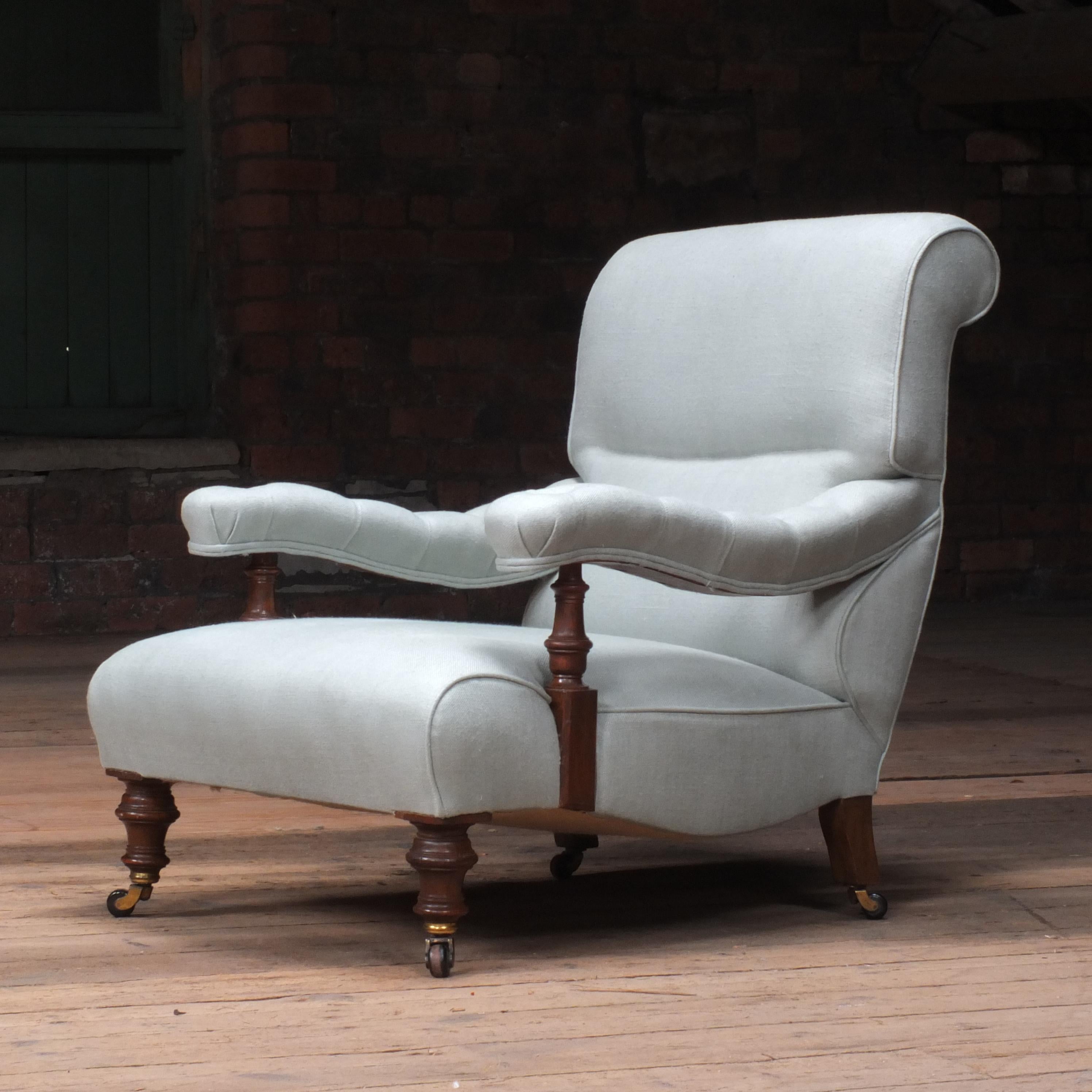 A very well proportioned deep seated 19th century open armchair in the manner of Howard and sons. Raised on turned walnut legs and newly upholstered by us in a heavy weight pistachio linen from Ada & Ina. The deep seat combined with the slope of the