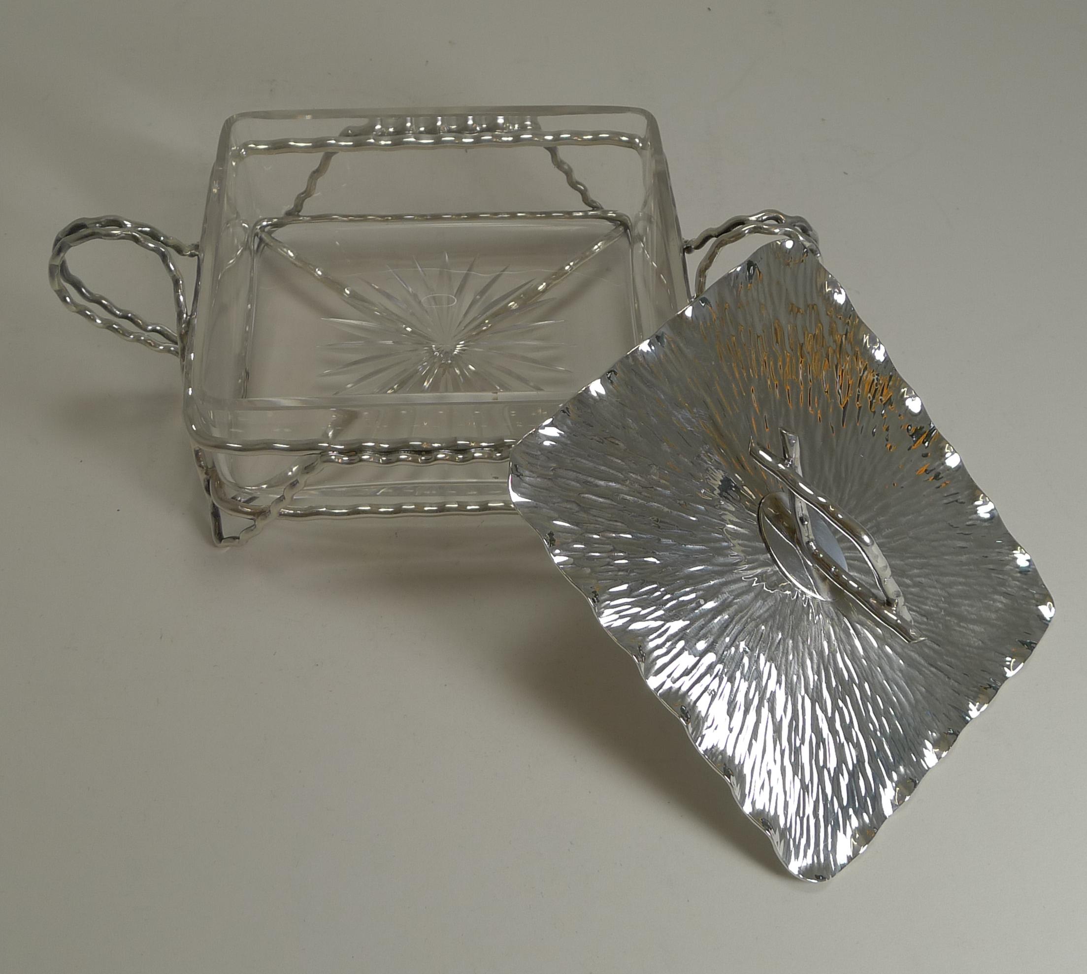 A wonderful example of a Victorian naturalistic piece attributed to Christopher Dresser and made by the famous silversmiths, Hukin and Heath.

The original glass liner remains intact and without damage.

Fully marked and in excellent condition.