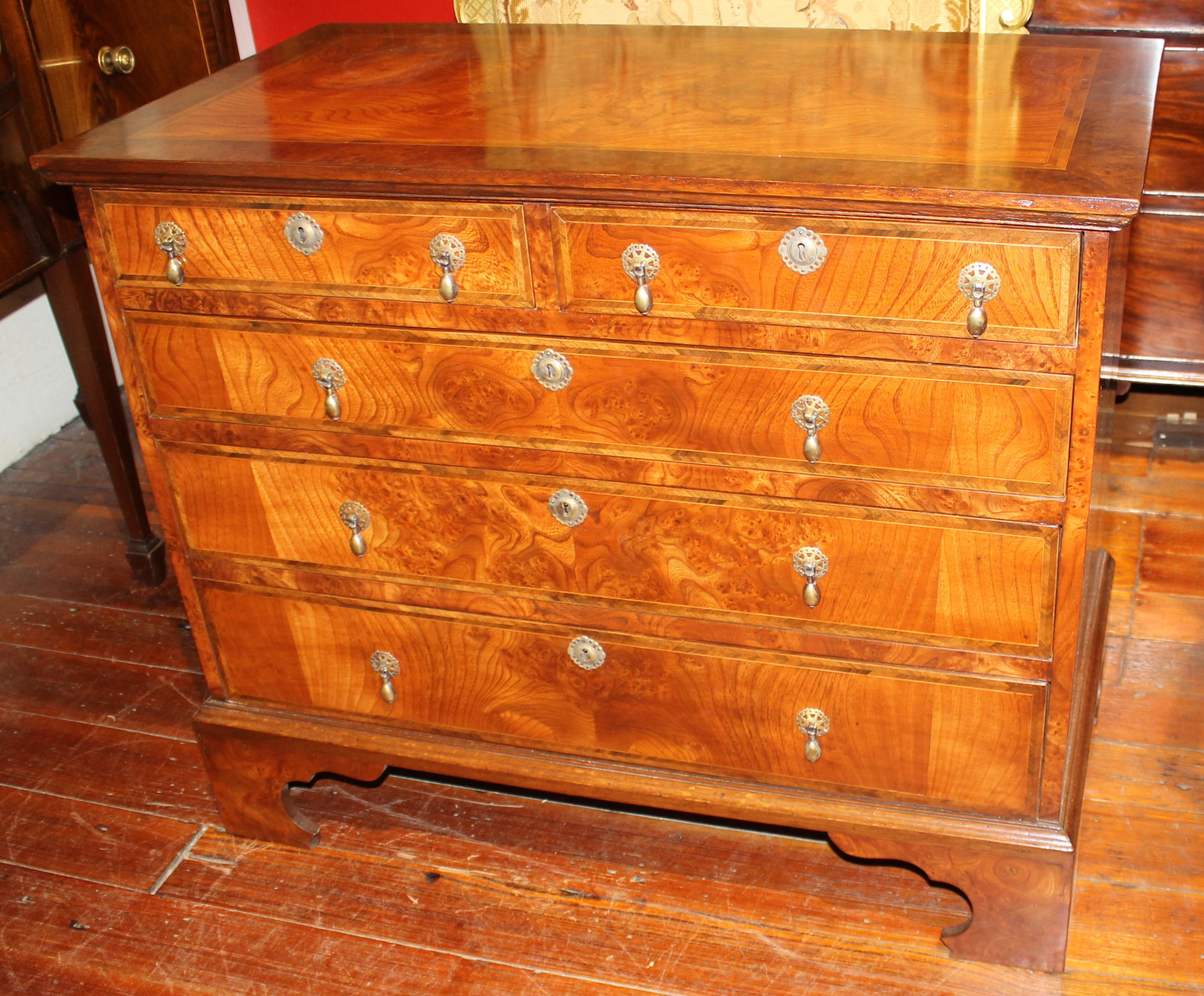 Superb quality antique English inlaid burr elm Queen Anne Revival Bachelor's chest. The Queen Anne Revival period in the mid-19th century borrowed on designs that were prevalent during the Queen Anne period of the early 18th century. Though this is