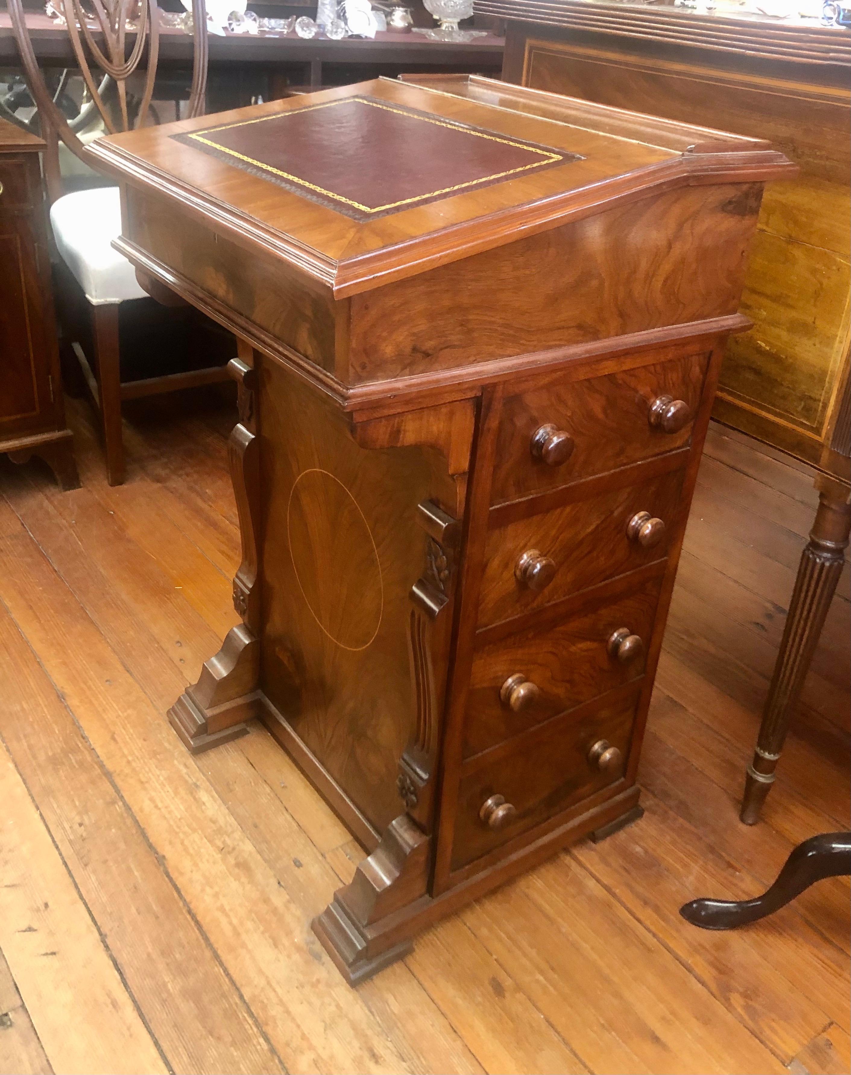 Fine quality antique English leather top inlaid burr walnut davenport or ship captain's desk with lift-up top revealing a series of side by side small drawers. The exterior has a bank of useful drawers one over the other on the left side with a