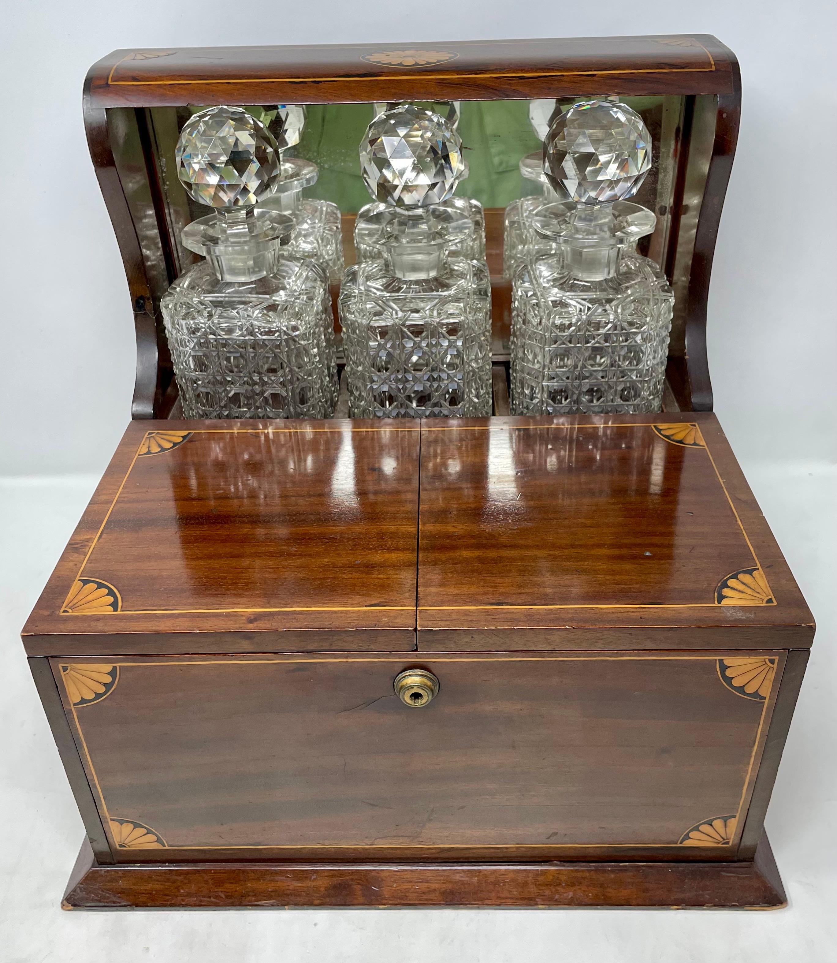 Antique English inlaid mahogany & cut crystal games box tantalus, Circa 1880.
Includes Crystal Glassware, Cigar Cutter, Silver-Plated Dishes and Games.
