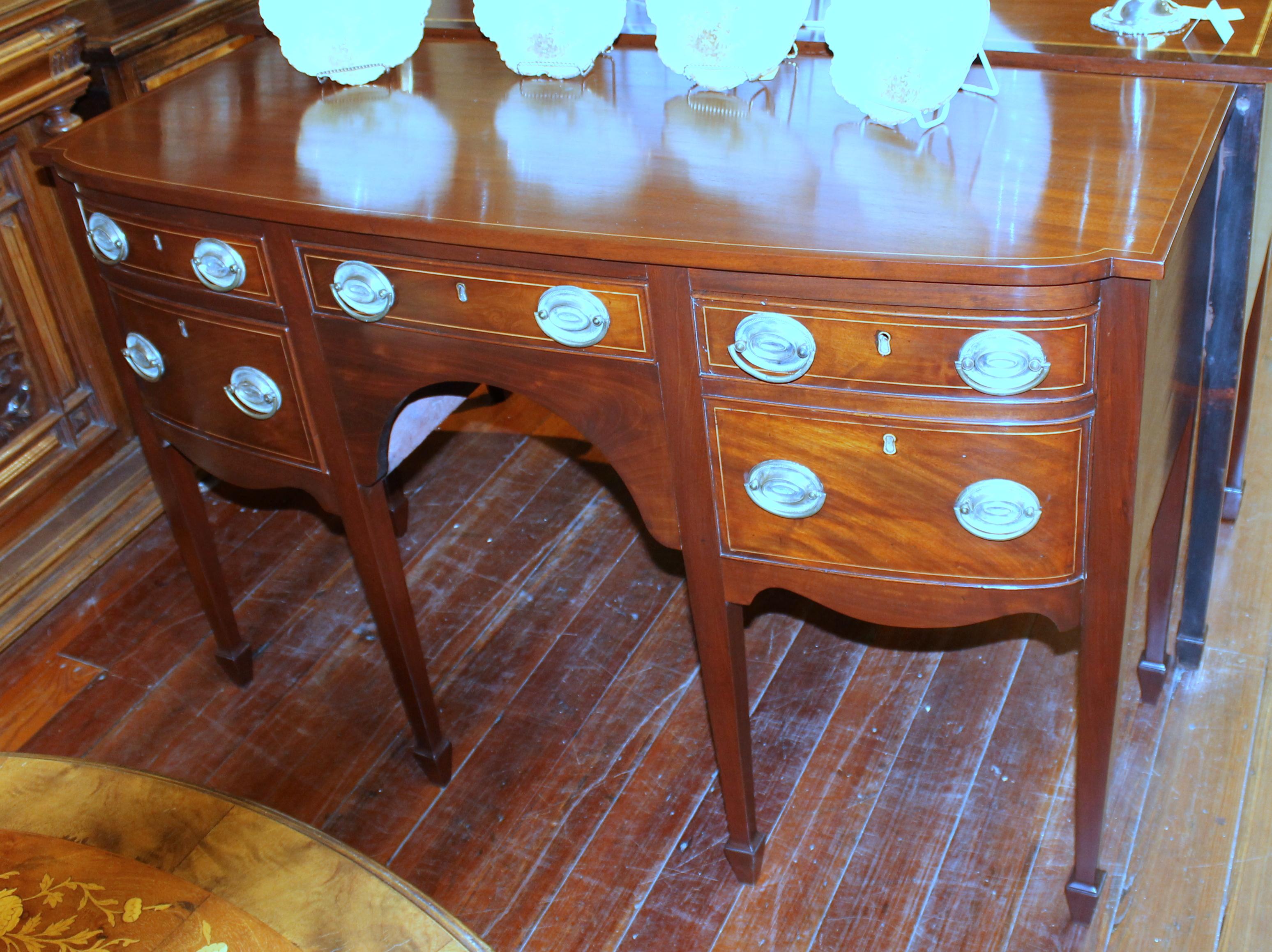 Fine quality antique English inlaid mahogany hepplewhite style George III bow-front sideboard with holly line inlay.

-Original ten brass handles-

Right sided cellarette drawer. (Please see images from behind drawer)

Superb condition.