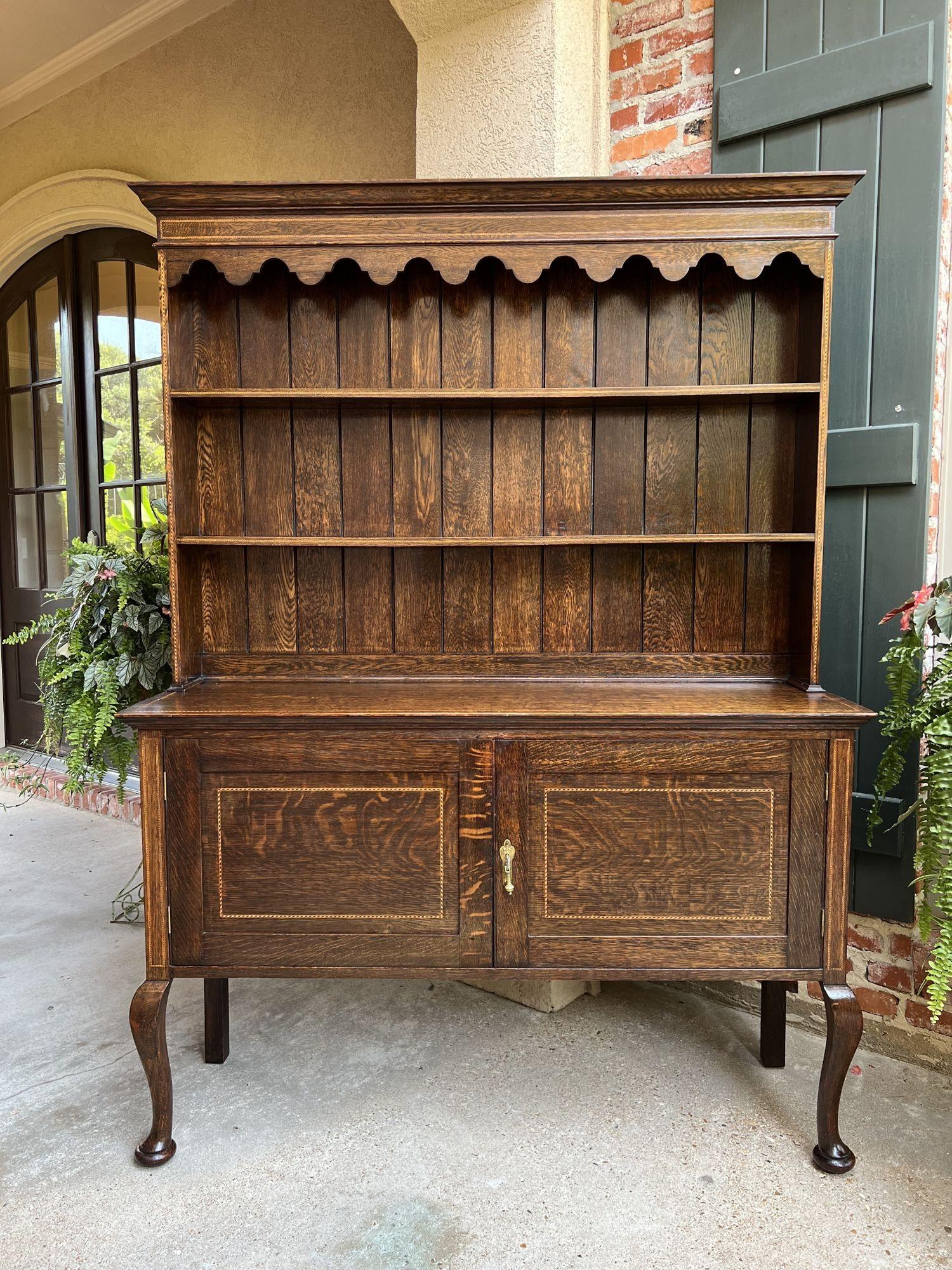 Antique English inlaid oak welsh dresser sideboard buffet hutch Queen Anne.
 
Direct from England, a classic antique English oak “Welsh Dresser” or sideboard.
Elegant silhouette, outlined with inlaid design around all the crown and upper shelf