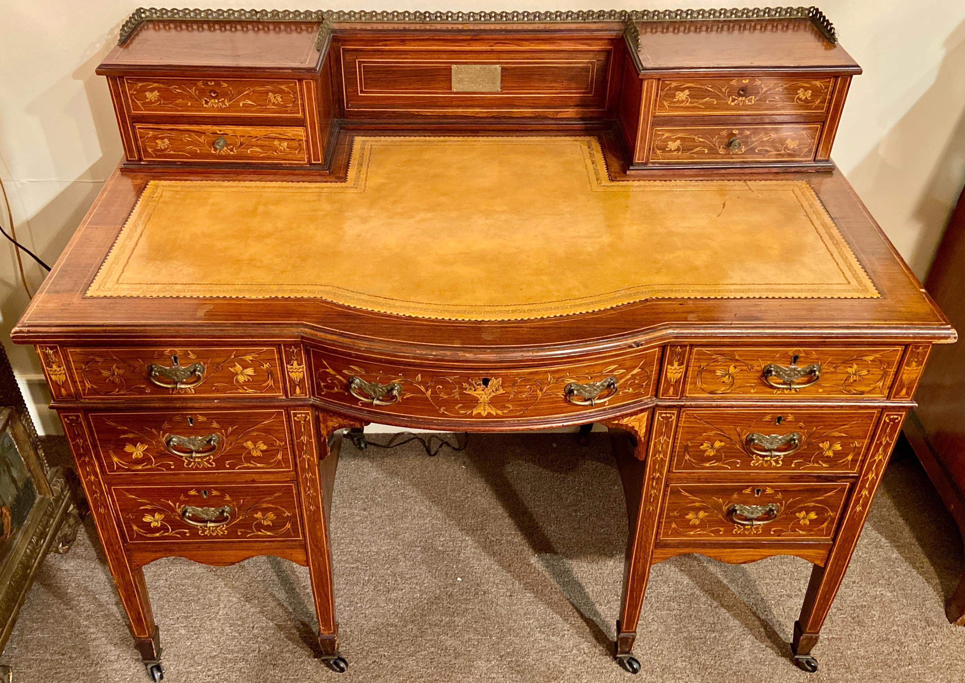 Antique English inlaid rosewood writing desk on casters with leather and galleried top, Circa 1890.