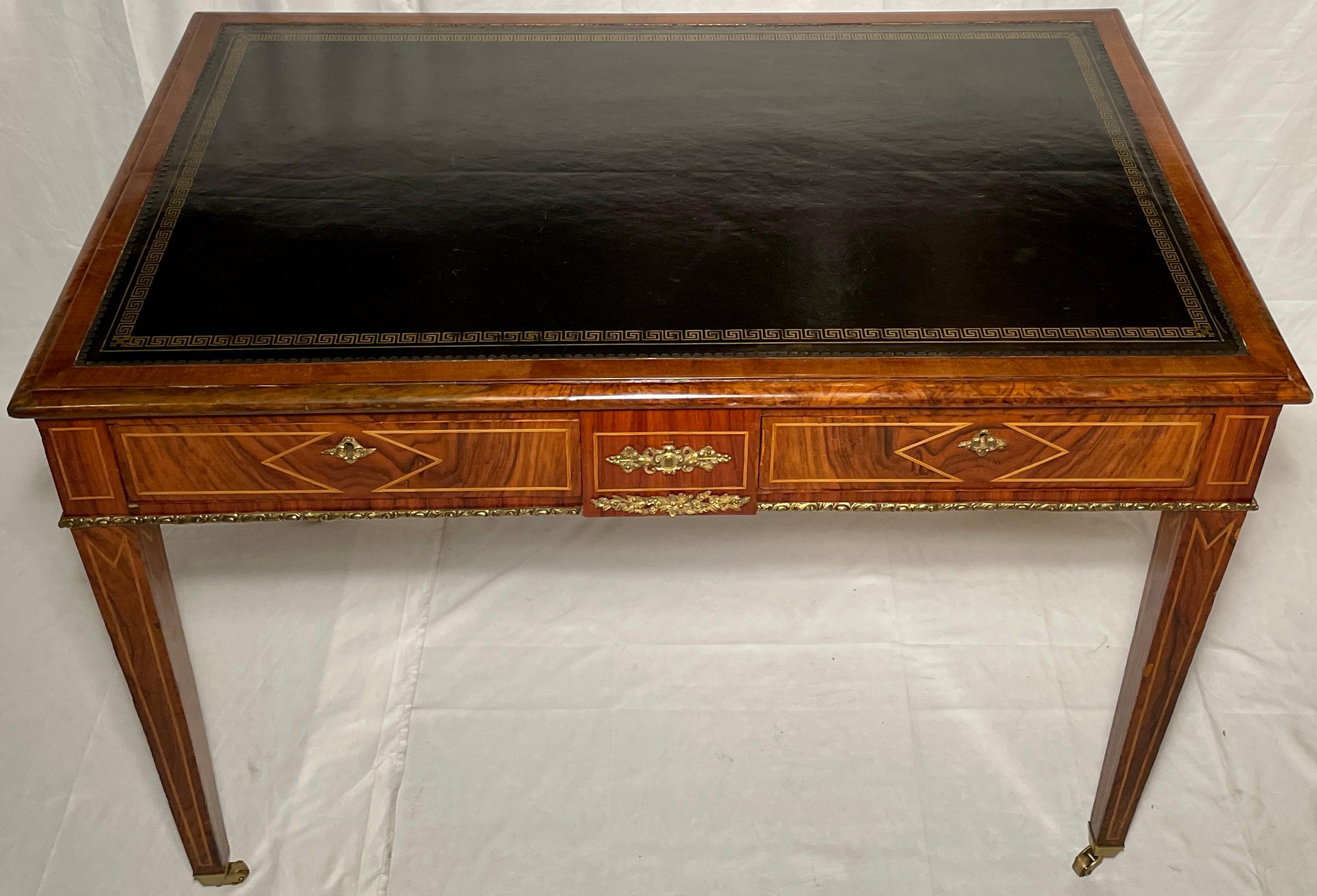 Antique English inlaid walnut and gold bronze mounted writing desk with black leather top, Circa 1880.