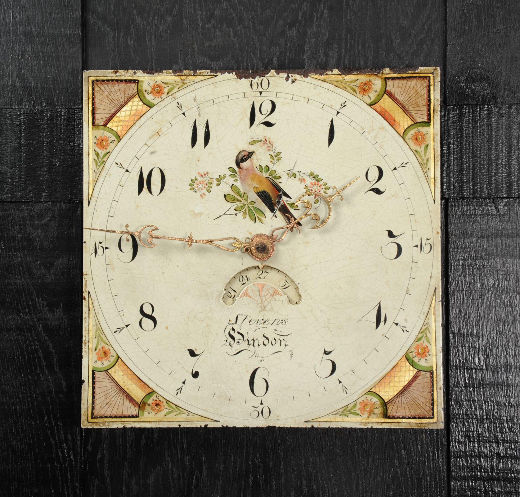 A lovely antique iron clock dial circa 1830 in its original enamel, charmingly decorated with a bird and flowers. With ancient craquelure, marks of a long life and its original handcut brass hands, all as found by our buyer on a local estate. The