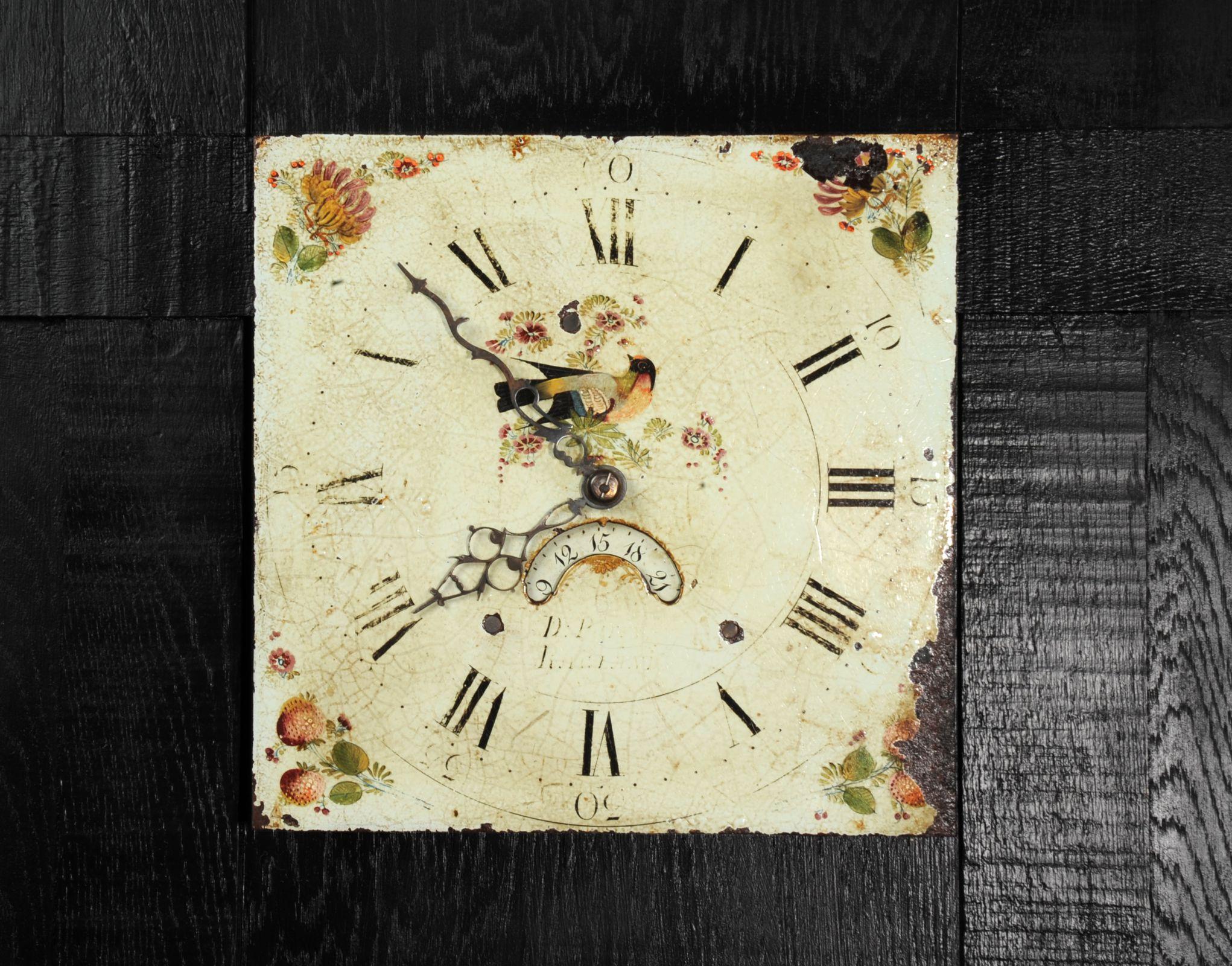 A lovely antique iron clock dial circa 1830 in its original enamel, charmingly decorated with birds and flowers. To the corners are charmingly painted flowers and summer fruits. With ancient craquelure,  rusty patches, marks of a long life and its