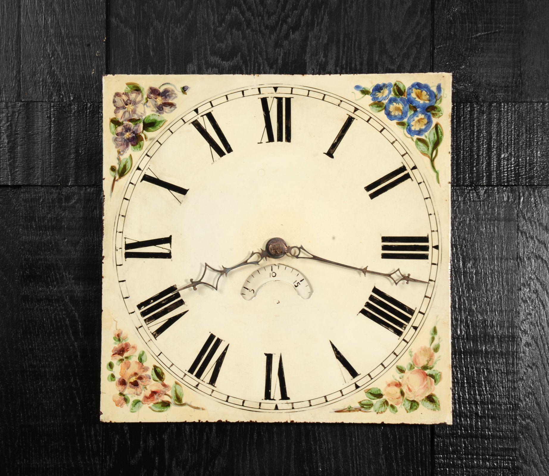 A lovely antique iron English clock dial circa 1840 in its original enamel, charmingly decorated and English country garden flowers. With ancient craquelure, marks of a long life and its original hand cut Iron hands, all as found by our buyer on a