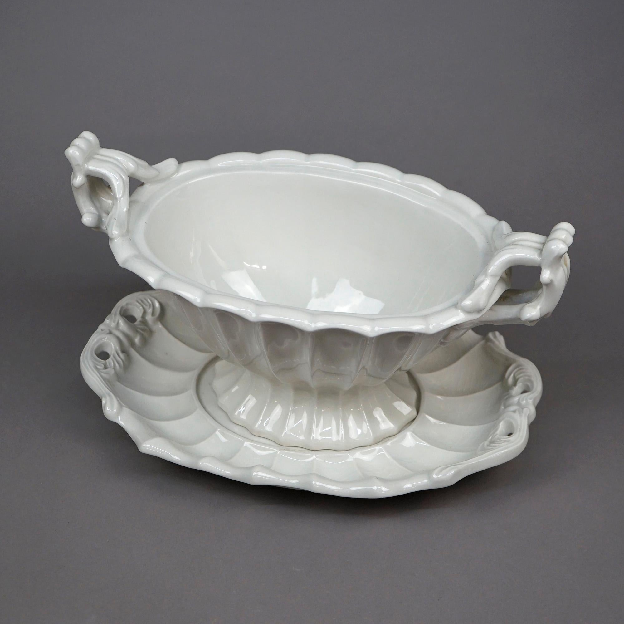 An antique English tureen offers ironstone construction with branch form handles, tray and lid, maker stamp on base as photographed, c1920

Measures- 11.5''H x 16.75''W x 10''D